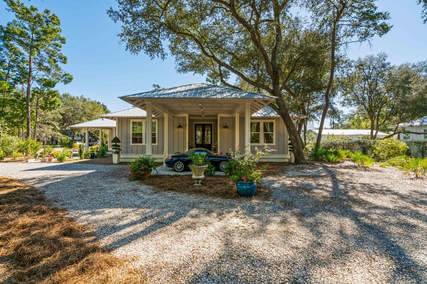 Welcome to Historic Point Washington and this custom built home in Eden Estates. Attention to detail is an understatement with 2,605 Sq Ft, 4 Bedrooms, 3 Full Baths, 5 bay garage, two space carport, a porte-cochere entry to the front door, ¾ of an acre and a screened in porch. The owners designed and built this home in 2019 with family and entertainment in mind. The open floor plan with spacious kitchen, living and dining area spill out to the covered porch. Once outside you are surrounded by the natural landscape covered with native trees, bushes, and plants encircling you as you meander through the garden on a paved path. Oak hardwood floors, quartz counters, 5 burner gas range, KitchenAid appliances, vaulted ceilings, are a few of the highlights along with a dream garage for the car lover, commercial grade lift, workout enthusiasts, or storage perfectionist! This home has is all and it's located just minutes from Eden State Gardens, boat ramp to Tucker Bayou, schools, shopping, beaches & restaurants of 30A.