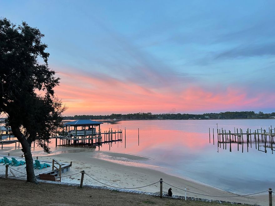 **Motivated sellers!** Bring us an offer** Spectacular Waterfront Town Home with Deeded Boat slip included !!!! On HWY 399 -East Bay Blvd - Opposite Hidden Creek Golf Course.Community Pool!!! Private Beach for Residents on Bay!!! Only minutes from the Gulf of Mexico and Navarre Beach. COMPLETELY UPDATED Town House nestled 25 feet from the watersedge with unobstructed views across East Bay from either the lower or upper decks.Enjoy incredible morning sunrises and afternoon sunsets from your own double private balconies where you can watch dolphins, eagles,Ospreys and enjoy the best of Florida wildlife. Kayaking right off the private beach. The Blue Angels can be seen from time to time flyingover the Bay! New entry fiberglass door with side window panel welcomes you into this spacious living spacewith bright kitchen and dining area. Nine foot ceilings add to the openness of the downstairs area. Kitchen has marble countertops, black composite sink, recently updated appliances with dishwasher, microwave and LG glass cooktop electric stove, plus a large Kitchen-aid double door refrigerator with pull out freezer drawer. Lounge area overlooks East Bay. The new Hurricane proof wide Low E doors offer great visibility and safety. The deck leads down to the water, your dock, and the beach area. The Swivel Rocker chairs and KomodoEgg Grill are included. The Kitchen also has a pantry and additional space under the stairs. A half bath with comfort height commode and custom vanity complete the space. Open stairwell and new LVP with matching stair treads leads upstairs. Landing area has the new laundry room with large capacity LG to washer and dryer and lots of additional wall mounted storage. Master Bedroom has king size bed with matching furniture and vaulted ceiling with ceiling fan. Sliding patio doors lead to outside balcony overlooking the bay. Tall Adirondack Poly deck chairs are included as is all the bedroom furniture. Open vanity area is fully tiled, has custom vanity quartz top and beautiful LED round backlit mirror. New custom built walk in shower has beautiful bevel subway tile with heavy glass barn style sliding doors and stainless steel hardware. Shower floor has none slip marble basket weave tile. Chair height commode, shiplap ceiling in shower and vanity area finish the modern look. Master bedroom has walk in closet. Second guest bathroom has beautiful blue granite vanity top with doors and drawers. Cabinet over seat height commode and linen closet provide ample room for linens and storage. Subway tile and glass sliding barn doors just like the master bath add to the modern appeal of this home. Guest bedroom at the front of the property has a vaulted ceiling with ceiling fan and large sized closet. TV is mounted on the wall for easy viewing.
The middle bedroom overlooks the walkway coming into the house.
There is a large closet for clothes storage. 6 inch baseboards and ceiling trim throughout the house adds a modern and clean feel.
There is a community pool located at the front of the property with
bathroom facilities. Newly renovated pool area with pavers and wrought iron fence invites you to cool off on those hot summer days.
The property is ideal for your new forever home or has great long or
short term rental potential due to the great location. The HOA fees are one of the lowest in town, around $125 a month. Wi-Fi Yale lock and Nest Thermostat enable you to control the property remotely. The Ring security cameras are also included. The roof was replaced in 2021 and the boiler 2022. Exterior was completely painted in 2022. There is extra storage shelving built in the garage. This property comes completely furnished and has been well maintained and is move in ready. Call today to set up a viewing!
