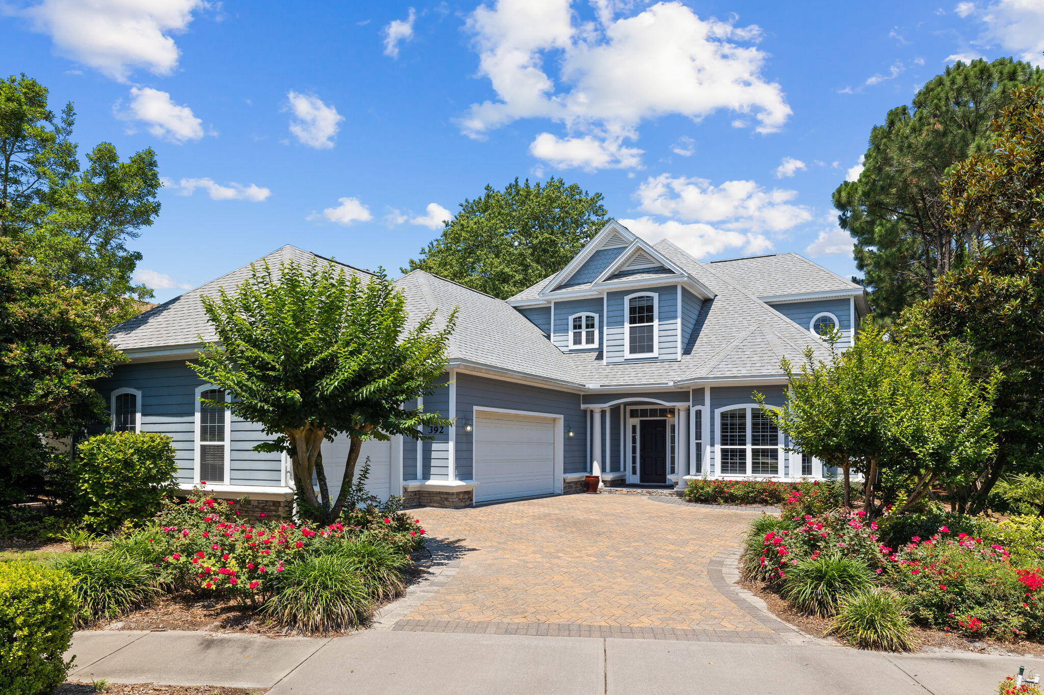 This custom-built home is ideal for anyone who values their privacy with a cul-de-sac location and natural preserve to the side and rear. A short walking trail leads to Bayou Park, which is popular with hikers, boaters, kayakers and fishing enthusiasts within this gated 900-acre community. This statement home has great curb appeal, a new roof and a paved driveway leading to a 3-car garage with epoxy flooring and ample space for a golf cart for getting around. The pillared entrance leads into a hallway with polished tile, revealing the quality craftsmanship of this luxury home. A plethora of doors hide a powder room, huge laundry with sink and storage and a spacious bonus room/office with built-in bunk and closet. The main event is the great room with impressive columns and crown molding There's a breakfast nook for casual dining and a granite-topped bar where keen mixologists can impress guests with signature cocktails. Doors lead out to a huge screened terrace for large-scale entertaining surrounded by greenery. Look forward to alfresco dining and relaxing beneath the stars in the in-ground spa and separate hot tub. The first-floor master suite includes a huge bedroom with wood-look flooring and a feature bay window. His-and-hers closets lead to the huge master bath, which has it all: jetted tub, twin cultured marble vanities and walk-in shower. Stairs lead to the remaining oversized guest bedrooms and another bonus room with built-in shelving on the second floor. Ideal for full-time coastal living or as a second home/quiet retreat, the home is close to multiple clubs and amenities including tennis courts, pickleball courts, a yoga/fitness center, playgrounds and community pools. There's a fenced dog park and an 18-hole golf course with stunning bay views providing an enviable lifestyle within easy reach of Destin Commons, Choctawhatchee Bay and beaches.