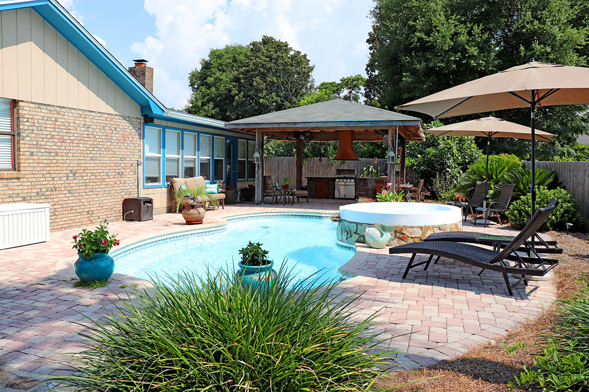 Looking for something that encompasses the luxury Destin lifestyle without the gated neighborhood restrictions or price tag...then ''Welcome Home!'' This home with 3 bedrooms & 4 baths + office has been immaculately maintained and is complete with a backyard oasis featuring lush tropical landscaping with mature and producing fig & avocado trees, a well appointed summer kitchen, salt water gunite pool & hot tub.This home was truly designed with entertaining in mind! The large kitchen with all GE Profile appliances opens to the living area with wood burning fireplace. There is a separate dining room, a bar area complete with ice maker, wine cooler and custom cabinets. Each Bedroom has its own en-suite bath. The large master has his & hers walk-in closets and jetted tub.