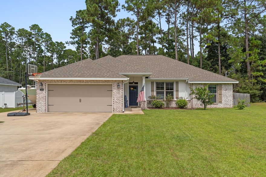 Welcome to this beautiful 2020 built home in the sought after Holley by the Sea community, offering resort style amenities including pools, tennis courts, fitness center, clubhouse, and waterfront access.This home boasts an open floor plan filled with natural light and numerous upgrades throughout. The kitchen features sparkling quartz countertops, subway tile backsplash, a slide in range, and pots and pans drawers, while the living area highlights modern finishes and durable luxury vinyl plank flooring. The spacious master bedroom includes an upgraded bathroom with quartz countertops, dual vanities, and a beautifully tiled shower. Additional enhancements include smart home features with door sensors and security panel, prewiring for home theatre surround sound, and a craftsman style front door.

Step outside to a private backyard oasis complete with a screened in patio with TV hookup, perfect for entertaining. The fully fenced yard backs to natural landscape for added privacy, while a well irrigation system keeps landscaping lush and helps lower water costs.

For outdoor enthusiasts, the side yard offers a parking pad with a 30 AMP outlet, ideal for a boat or RV. Peace of mind comes with the Taexx in wall pest control system and maintained termite protection since construction.

Enjoy modern comfort, energy efficiency, and entertainment ready outdoor living, all with access to the unmatched lifestyle of Holley by the Sea in this gorgeous Navarre home.