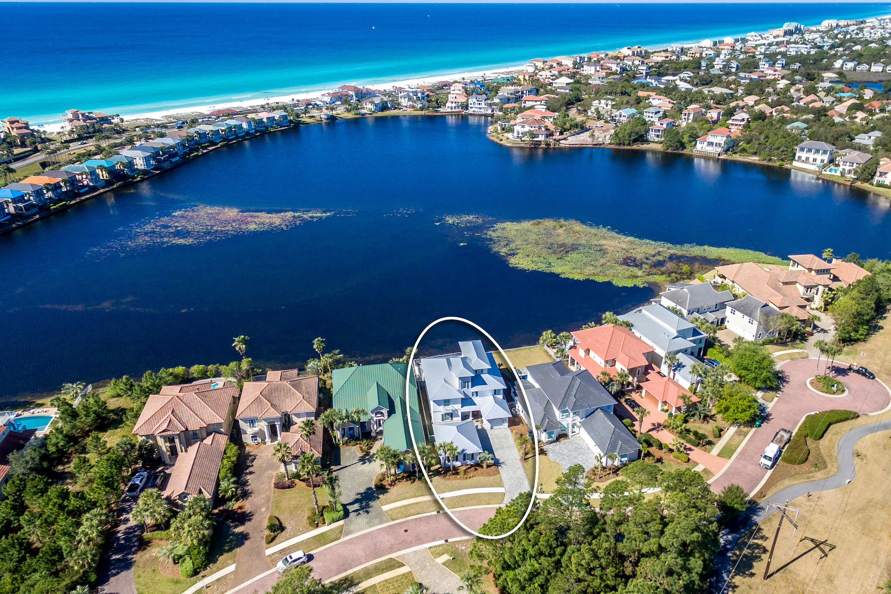 This house is located on one of the most premier lots in Destiny East and has one of the most spectacular views in the Destin/Crystal Beach area overlooking a freshwater lake teaming with wildlife and views of the gulf! Destiny East is a premier gated community with entrances on both Highway 98 and Scenic 98, just a short distance to the crystal-clear emerald waters and white sandy beaches. Outstanding community facilities include pool, tennis courts, playground, exercise room, and movie theatre. Wildlife abounds on the lake including bald eagles, ducks, osprey, pelicans, blue herons, owls, turtles, and fish. Feed the ducks and fish off the pool deck. The location of this lot, on the short and extremely quiet, limited traffic, Rendezvous Cove cul-de-sac road, and the views, are