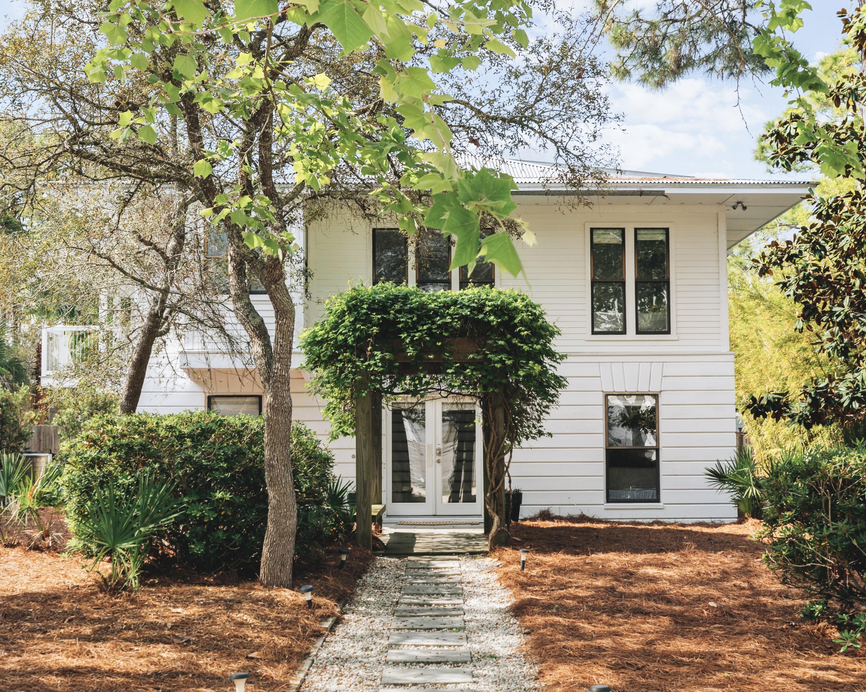 Located in Old Seagrove at the end of Canal Street, this delightful beach cottage is just steps from Seaside, Florida, public beach access and everything 30A has to offer. Boasting nearly 3,800 square feet of living space and six bedrooms plus two bunks, this is an ideal rental property or coastal getaway. The interior of the room is finished with wood flooring throughout the main living areas and vaulted ceilings in the living room that brings in abundant natural light. Two bedrooms on the first floor share an en suite bath and morning kitchen. There is a separate entrance to these two rooms plus morning kitchen area that could be rented as a separate lockout space. The second floor of the home is where you'll find the stylish kitchen with gas range and bar seating along with three additional guest bedrooms and the owner's suite with private bath and balcony access. Laundry rooms on the first and second floor add convenience. The piece de resistance of this property is its backyard oasis complete with a 12,500-gallon, private, heated pool, large pool deck, outdoor shower, and spacious entertaining area that includes chaise lounge chairs, a grill and outdoor dining surrounded by lush tropical landscaping that lends privacy. A two-car garage and ample parking offer room for everyone. Known for its tree-lined streets and easy beach access points, Old Seagrove is a coveted community near the sugar-white sands of the gulf, just a quick drive away from all of the shopping and dining on Scenic Highway 30A and beyond.