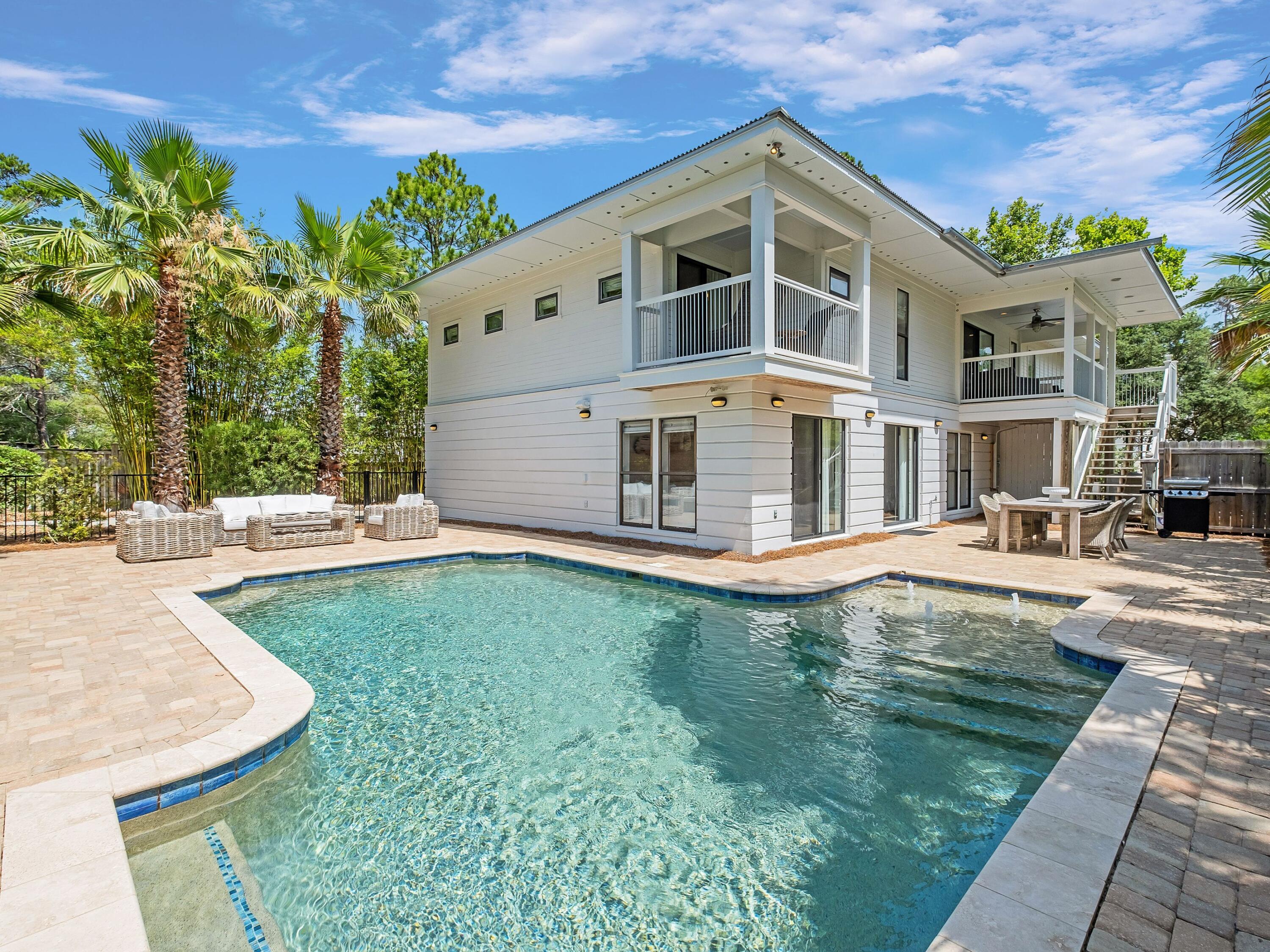 Located in Old Seagrove at the end of Canal Street, this delightful beach cottage is just steps from Seaside, Florida, public beach access and everything 30A has to offer. Boasting nearly 3,800 square feet of living space and six bedrooms plus two bunks, this is an ideal rental property or coastal getaway. The interior of the room is finished with wood flooring throughout the main living areas and vaulted ceilings in the living room that brings in abundant natural light. Two bedrooms on the first floor share an en suite bath and morning kitchen. There is a separate entrance to these two rooms plus morning kitchen area that could be rented as a separate lockout space. The second floor of the home is where you'll find the stylish kitchen with gas range and bar seating along with three additional guest bedrooms and the owner's suite with private bath and balcony access. Laundry rooms on the first and second floor add convenience. The piece de resistance of this property is its backyard oasis complete with a 12,500-gallon, private, heated pool, large pool deck, outdoor shower, and spacious entertaining area that includes chaise lounge chairs, a grill and outdoor dining surrounded by lush tropical landscaping that lends privacy. A two-car garage and ample parking offer room for everyone. Known for its tree-lined streets and easy beach access points, Old Seagrove is a coveted community near the sugar-white sands of the gulf, just a quick drive away from all of the shopping and dining on Scenic Highway 30A and beyond.