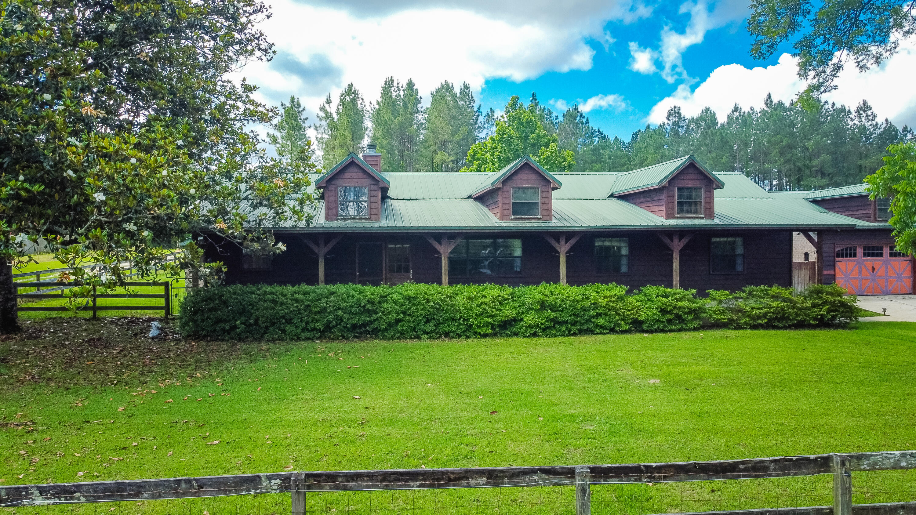 Charming Horse Property Just 45 Miles from White Sandy Beaches!This stunning property features a spacious 3-bedroom, 2-bath main home filled with classic country charm, soaring ceilings, and an open-concept living area. Recent updates include a beautifully renovated laundry room, modernized bathroom, and refreshed office space. Step outside to an entertainer's dream with a covered outdoor kitchen and patio, a relaxing pergola, and a large garage for all your storage needs. Also included is a full 3-bedroom, 1-bath guest house or mother-in-law suite with its own private entrance -- perfect for extended family, rental income, or hosting guests. Equestrians will love the 36x60 barn, complete with 4 stalls, hay storage, power, water, and tack room.