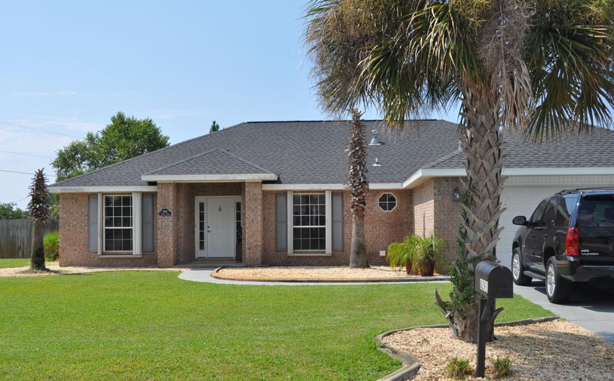 Beautiful 3/2 home offers an open floor plan that sits on a sizable corner lot. Stunning kitchen offers GE Slate appliances, tile floors, contrasting granite, mosaic tile back splash, breakfast nook, island & breakfast bar that overlooks the great room. Bay windows permit a wealth of natural light. Laundry room exits into garage and directly to the extended concrete pad for a boat or RV. Great room features a corner fireplace, hardwood floors, 5'' baseboards, plant ledges, vaulted ceiling and sliding glass doors that flows out to the open patio for entertaining in view of the Palm Trees & landscaped back yard. Escape to the Master Suite & Master Bath that renders a garden tub, separate shower, dual vanity granite counters, vessel sinks & large walk-in closet. Hurricane Shutters Installed.