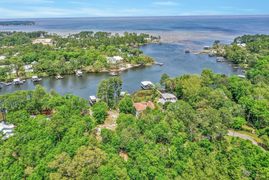 Beautiful deep water bayou front lot on Hewett Bayou.  Brand new dock with boat and jet ski lifts.  This lot is close to 1/2 acre with 105' of waterfront facing NW looking out towards the opening of the Bayou and the Choctawhatchee Bay. Enjoy the serenity of waterfront living yet close in proximity to Sacred Heart Hospital , the shops & restaurants of Grande Boulevard, and the beautiful white sand beaches of 30A.