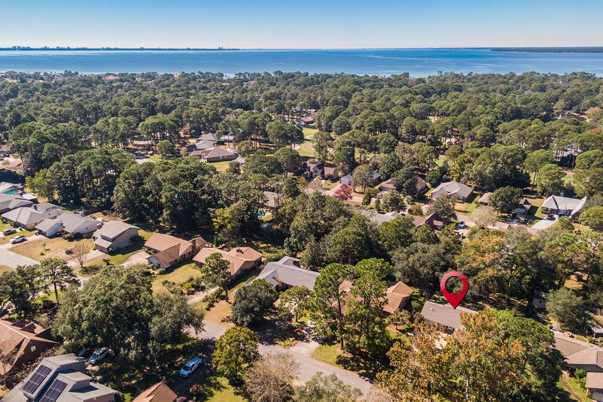 Tucked on a quiet street in the sought-after Bluewater Bay community this one-level, traditional ranch has been lovingly maintained and updated. The split floor plan allows for privacy between the 3 bedroom, 2 bathroom home with just over 1600 square feet of living space and a cozy enclosed back porch. Lux LVP flooring throughout (2020) with tile in the bathrooms.(No carpet anywhere) The kitchen was refreshed with stainless steel appliances, professionally faux finished cabinets, granite counter tops with a wonderful window over the under mount sink and a walk-in pantry. Breakfast nook just off the kitchen for everyday meals. New paint throughout the interior in 2022. The living room welcomes with vaulted ceilings and huge windows that bring in the natural light. The primary suite is large