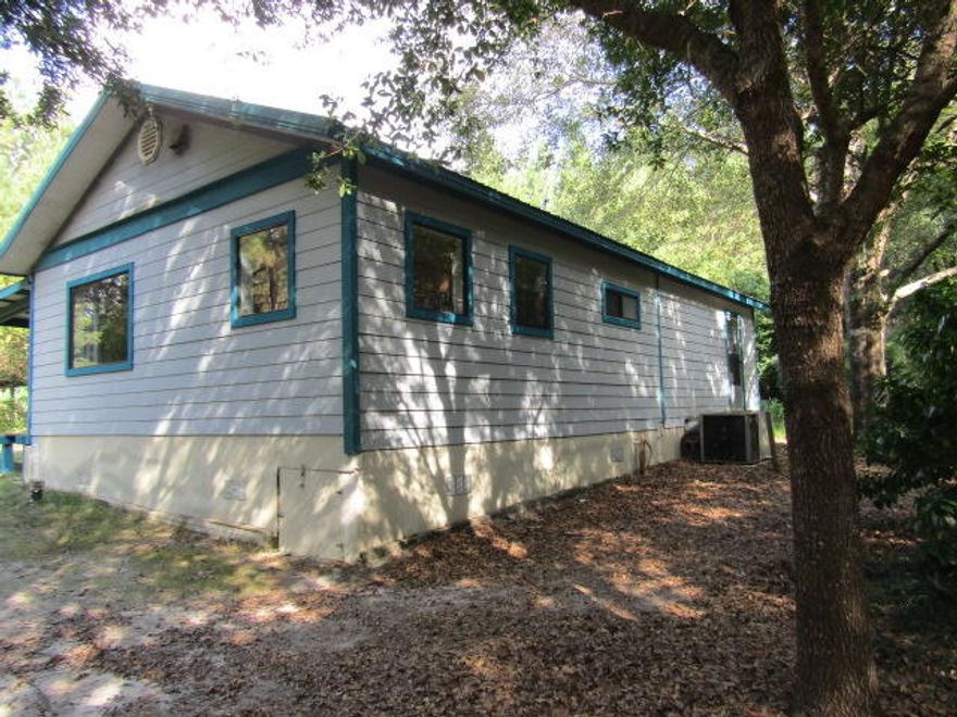 This cottage style home is built in the middle of 20 acres of nothing but peace and quiet. The bedroom/great room is extra large. The kitchen/dining room has granite counter tops, plenty of beautiful cabinets, and a large picture window with four other windows to enjoy the view of all the wildlife in their natural habitat. The large bathroom has a combo shower with tiled walls and vanity has a solid surface counter top. The home is located in an elevated position surrounded by Hardwoods and Pines. This land abounds with deer and turkey for the hunter in your family while never leaving the comforts of home. The seller also has a large garden area that he maintains for growing his own vegetables and fruit trees.