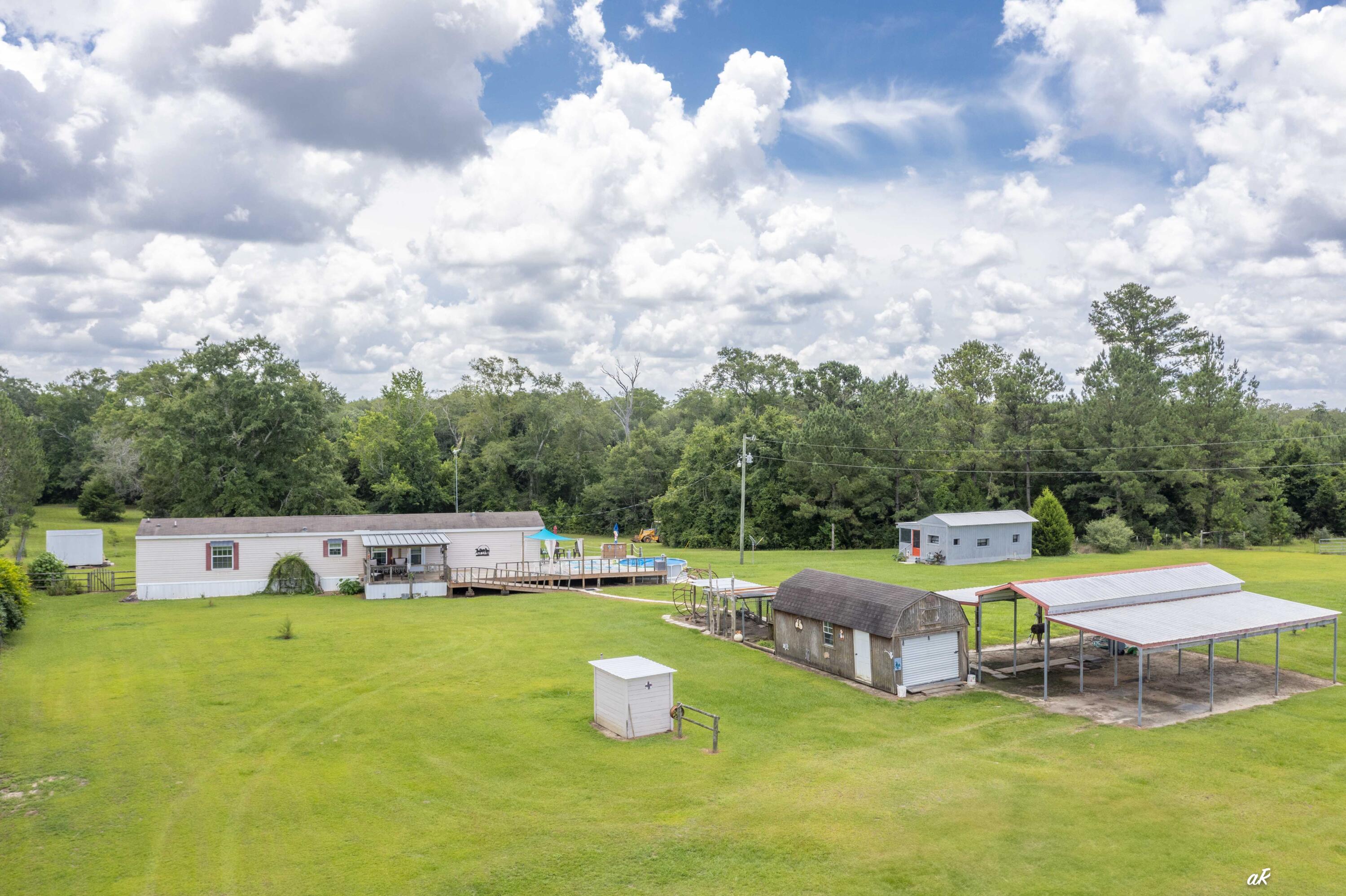 Nestled in a tranquil setting, this 15-acre property offers well-manicured pastures, a main home, a cottage, a 36x36 open-air barn, two sheds, one being 12x24 with a loft and the other that is 12x16 and a 10x20 chicken coup! All of this makes for an ideal home for anyone seeking a well-kept living space accompanied by functional outdoor facilities.**Main House Features: **The spacious main residence exudes fresh appeal with all interiors newly painted. It consists of three bedrooms, two bathrooms and an open concept living, kitchen and dining area. The house is equipped with all appliances. The dishwasher and a washer are just a year old, ensuring modern comforts. The addition of a new water filter system last year continues to guarantee clean and safe drinking water. There is a covered extra-large deck for entertaining or leisure, and a newly built deck to a 15-foot above-ground pool for warm-weather enjoyment.
The property is meticulously maintained with full fencing, cross fencing, and gated entries that assure both security and privacy. It supports agricultural activities, thanks to a shared well system with a neighboring 2-acre parcel. Well-designed with dual-horsepower capabilities extending 180 feet deep, supplying ample water for household and farming needs.
**Cottage Details: **
Adjacent to the main house is a charming 1-bedroom, 1-bathroom cottage that embodies rustic charm and additional privacy. It includes a full-length screened-in porch, which provides a perfect spot for relaxing evenings, protected from the elements, and it over looks one of the pastures.
**Outdoor Amenities: **
The property's outdoor features are exceptionally functional, with multiple water spickets located around the premises - front of the main house, backyard, near the gate at the pasture past the cottage, and alongside the front pasture. Each of these placements ensure that water access is convenient, irrespective of where one is on the property. For convenience, the property includes two automatic livestock water supplies, which are essential for rural living. There is a useful shed with a loft area, perfect for storage or creative space, a backyard shed with electricity, ideal for projects or extra storage, and an outdoor water spicket for convenient gardening or other outdoor activities. There are also deer that frequent the property on a daily basis.
This property is a perfect blend of comfort and functionality, designed to cater to both residential and agricultural needs. It's an excellent choice for those looking to enjoy country living with all the necessary modern conveniences. All that's missing are your horses!