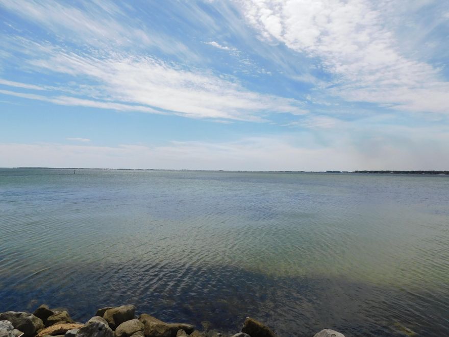 Don't miss this golden opportunity. The Association is finishing up on the exterior of all the unit with new vinyl siding and roofs.  This unit has had all of the aluminum wiring replaced with cooper, new light fixtures throughout, new flooring in living room area and bedroom, new vanity in bathroom, tub resurfaced, subway tile on backspash in bathroom and kitchen, cabinets in kitchen repainted and new handles, new dishwasher on it way, new mirror and light fixture in bathroom, freshly painted through out.  Nothing left to do but enjoy the afternoon looking out over the lake outside your sliding door.