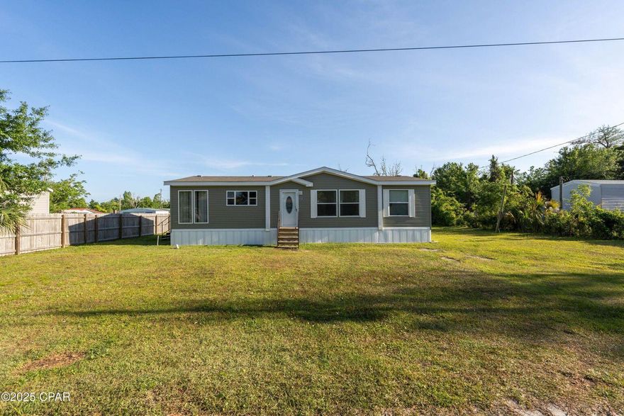 Spacious and move-in ready, this 2021 double-wide mobile home offers 3 bedrooms, 2 bathrooms, and an open layout that provides comfortable living with plenty of room to relax or entertain. The split-bedroom design adds privacy, and the large kitchen and living area give the home a bright, open feel. The Living room is so spacious and features built in shelving. The kitchen features beautiful black appliances. The master suite boast double vanities, separate shower and a garden tub for relaxing. Situated on a generous lot, there's plenty of space for your boat, RV, or additional vehicles--plus, no HOA restrictions. Located in Panama City, you're just minutes from beautiful Gulf Coast beaches, top-rated fishing spots, and a variety of dining, shopping, and entertainment options. Whether you're looking for a full-time residence or a coastal getaway, this property offers flexibility, space, and convenience. *STORAGE SHED DOES NOT CONVEY**