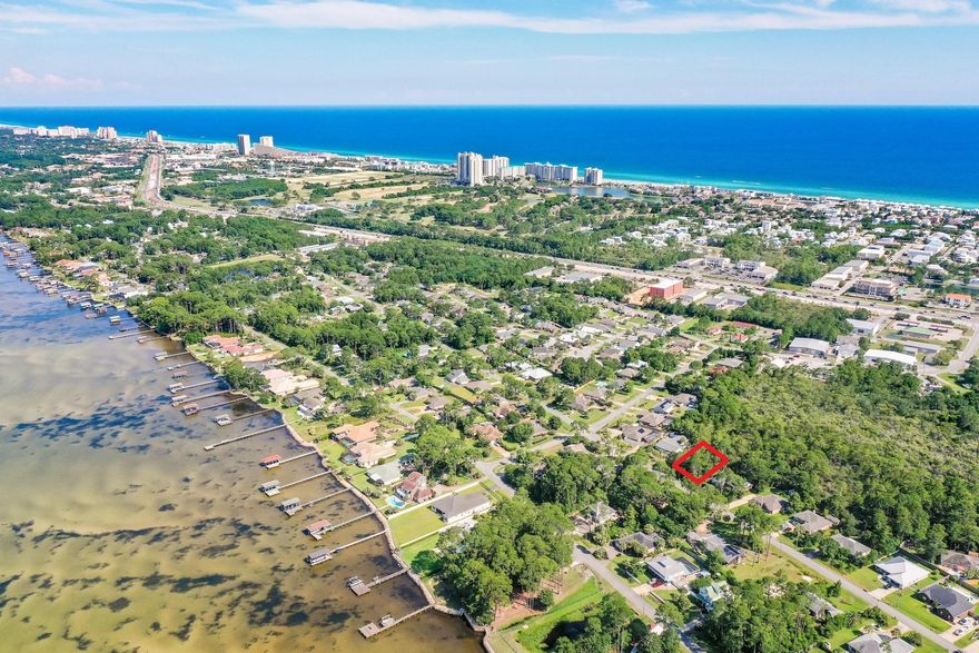 Build your dream home on this SPACIOUS LOT WITH TAP FEES PAID!! Just over a quarter acre (0.27) in the Holiday Shores Estates subdivision of Miramar Beach with NO HOA FEES! Lot 12 is perfectly located close to everything coastal living has to offer. It is right next to Emerald Bay Golf Club, Silver Sands Premium Outlets, within 1.5 miles to bayfront Legion Park which has a public boat ramp with access to Choctawhatchee Bay, and only 1 mile from the pristine beaches of the Gulf of Mexico which can easily be traveled by golf cart or bike right down Holiday Road. Build your dream home with no build out time or building restrictions and start living that coastal lifestyle you desire with boating, fishing, kayaking and paddle boarding just outside your door.