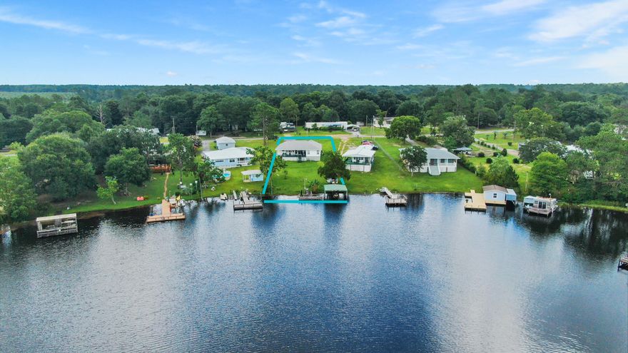 Immaculate waterfront home on beautiful Lake Juniper, where great fishing is steps from your back deck. This one owner vinyl siding home with 2 car attached garage is easy maintenance with beautiful WSW views of spectacular Florida sunsets from the covered back deck, dock and boathouse. Upon entry, you have water views greeting you, along with vaulted ceilings, helping to make it feel open and airy. Comfortable layout with large kitchen pantry & utility with room for freezer. Huge waterfront master bed with double walk-in closets. Other bedrooms are spacious also. Everything is in tip top shape and clearly well maintained. Irrigation system for the lush green lawn supplied by the lake. Banana tree has actual bananas. This is the part where I say you're going to go bananas over this one! ;)