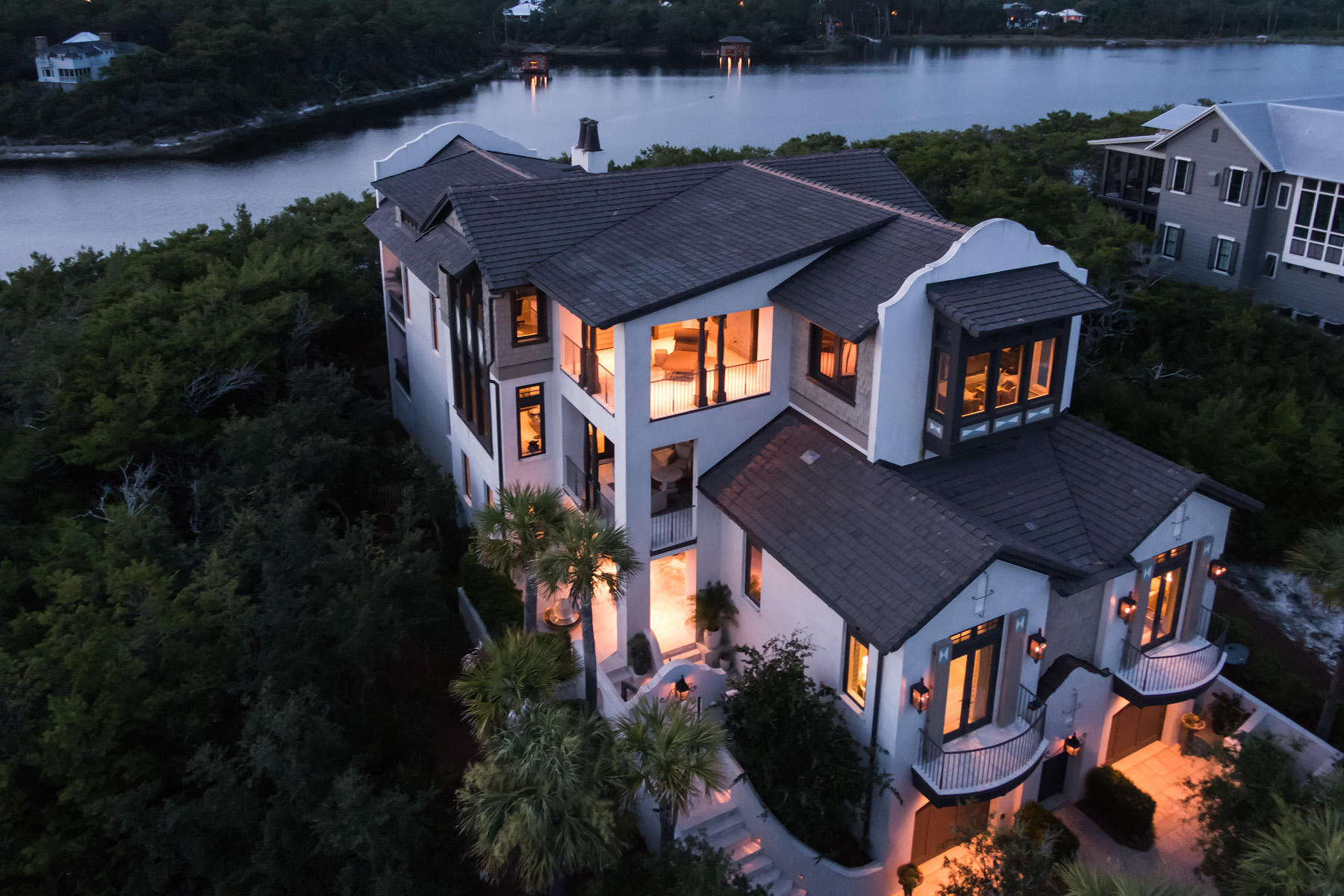 A lakefront legacy home for the architectural connoisseur, this show home was the first of its kind to be built in The Retreat, introducing a Dutch Caribbean style to the gated, Gulf front neighborhood. This style heritage is characterized by parapet walls and smooth stucco coating over the cement block exterior. Two of the most preeminent luxury home design firms in Northwest Florida approached the project with the intention of creating the finest home possible for the site. Custom details reveal themselves with time, and new discoveries are made with each experience. Across the street is the most scenic beach access in The Retreat, skirting majestic dunes as it approaches 3,000 feet of pristine private beach front.