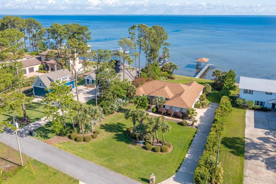 Seeking a great return on an investment property or second home with no HOA, come see this amazing single-story home on a huge private lot, directly waterfront on the Choctawhatchee Bay. This home has it all - vaulted ceilings, Chef's kitchen, 2 bars, huge dining room, separate family room, LED lighting, covered outdoor space, and a beautiful outdoor oasis with a fenced yard, Fruit trees, Palm trees, and a beautiful dock complete with boat lift. This home was designed with a split floor plan. The Owner's and guest bedrooms are separated by the large open kitchen and dining room. The Owner's suite has direct access to the beautiful lawn and breathtaking view of the bay via the 100 ft aluminum seawall. There is a large 2 car garage and expansive driveway for your RV or boat.