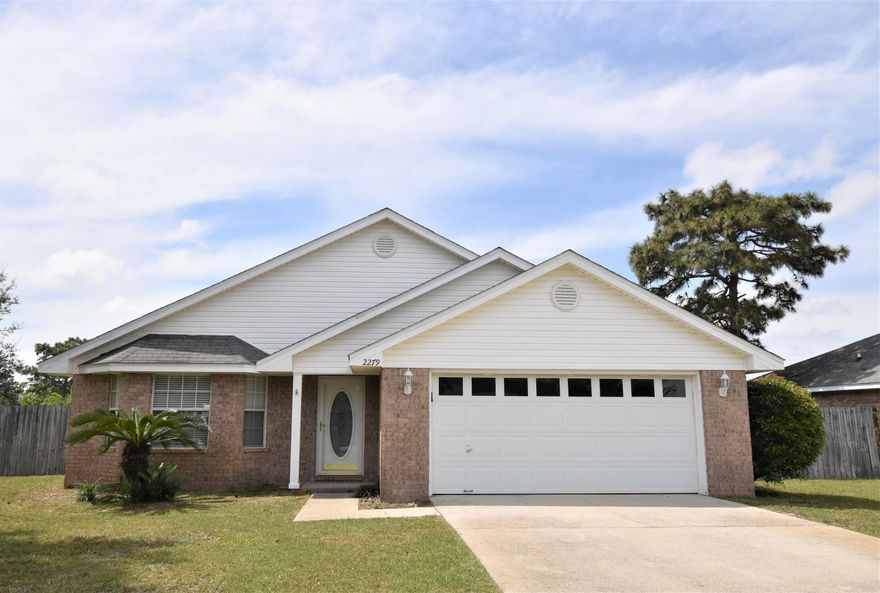 East Navarre location - faster access to bases and Fort Walton Beach and Destin. NEW ROOF 2019! New flooring 2019 to include luxury vinyl plank and carpet. New hot water heater. HUGE BACKYARD is large enough for a POOL. Buyer to verify all measurements. 2 main living areas can be used for living, dining, flex space - you choose how it works for you! Fireplace, separate laundry room. Great floor plan with easy flow, divided living areas, split bedrooms. Enjoy the view from the kitchen - the open floor plan allows those in kitchen to see the cathedral ceilings and picture windows - imagine what you could be seeing in your private backyard. Close proximity to beaches and shopping in Navarre. Sprinkler system for easy lawn maintenance, security system to rest easy.