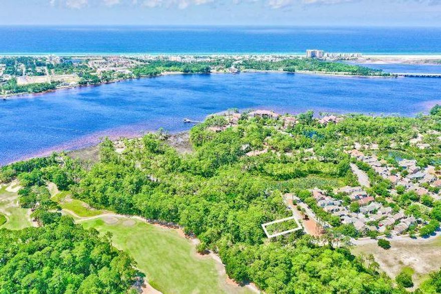 Price Improvement!  An excellent opportunity awaits you in the beautiful gated community of Wild Heron, a 734-acre Coastal Sanctuary, located on the shores of Lake Powell, Florida's largest coastal dune lake. Located in Prospect Point, this .21 acre lot sits across from a park and green space with a beautiful lily pad pond nearby which makes for a peaceful setting.  It backs to fairway 7 and conservation area, is in flood zone X with no flood insurance required and is only a short walk, bike or golf cart ride to world class amenities overlooking Lake Powell. The look and feel of Wild Heron is like nothing else on earth and is truly a one-of-a-kind community with a distinctive home design style known as 'Coastal Craftsman' and is filled