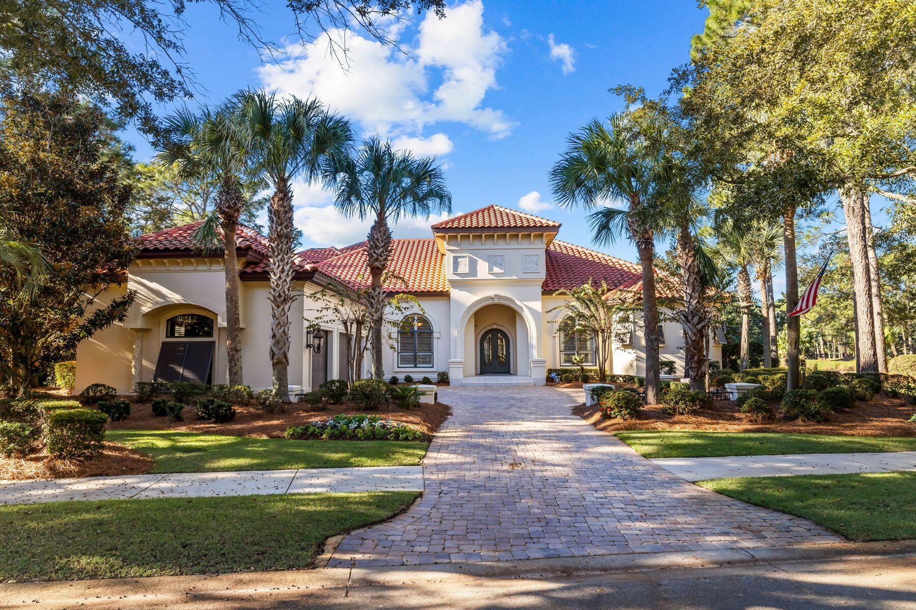 Discover the epitome of coastal elegance in this exquisite 5-bedroom, 4-bathroom residence nestled on a private lot (0.9 acre) on a lake within the exclusive Burnt Pine community of Sandestin Golf and Beach Resort. This stunning home offers breathtaking views of the Raven Golf Course and is a golfer's paradise. This home is a chef's dream with top-of-the-line appliances and a large island perfect for entertaining. Soaring ceilings, abundant natural light, four fireplaces, and seamless indoor-outdoor living spaces create a luxurious atmosphere even including your very own wine cellar.  A private retreat with a spa-like bathroom, spacious walk-in closets, and a peaceful sitting area highlight the master suite conveniently located on the first floor. Enjoy the Florida sunshine on your private pool deck, complete with a sparkling heated pool and hot tub, fireplace, and a built-in summer kitchen. The screened pool, lanai, and grilling area are what Florida living is all about. There is plenty of space to lounge and sun around the pool and hot tub. The Raven Golf Course's 11th hole runs behind the home, so everyone will enjoy the lake and golf course views while taking in the warm Florida weather. The covered dining and grilling area have it all: TV, counterspace and cabinets, and a new stainless, built-in grill. 

Additional features of this residence include a stately private office also located on the first level, a guest suite located on the second level with a private balcony and spacious porch, four fireplaces, a whole house generator, hurricane shutters, complete HVAC replacement, and all new pool screens in 2022. A golf cart is included with this home to easily access all the dining, shopping, and beach your heart desires in the Sandestin Golf and Beach Resort as well as golf cart accessibility to all the amazing eateries in Grand Boulevard.

This home has never changed hands and has had one continuous owner who hand picked this very desirable lot and built the home. A must see today - this home is extremely well cared for and maintained.
The Sandestin Golf and Beach Resort features more than seven miles of beaches & pristine bay front, four championship golf courses, 15 world-class tennis courts, a 226-slip marina, a fitness center, and spa & celebrity chef dining. This home has been meticulously maintained and is ready for your private viewing today! 