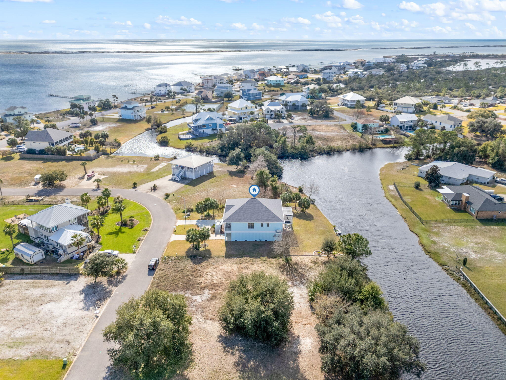 Welcome home to your very own waterfront home in the ever-popular Grande Lagoon! Newly built in 2018, this immaculate 3-bedroom, 2.5-bath residence is absolutely stunning & perfectly situated near the Intracoastal Waterway & the Gulf of Mexico, resting serenely on the lagoon with its own seawall & dock. Equipped with an elevator, access is a breeze throughout the home. The open & welcoming floorplan is a dream come true & high ceilings add the perfect aesthetic to the residence. Enjoy the 2-year new screen room off the back porch, which flows seamlessly with the design of this coastal abode. The updated landscaping creates a haven for watching herons, ospreys, eagles, & even the Blue Angels soar overhead. A whole-house generator, underground sprinkler system with timer, landscaping lights whole-house vacuum, & a security system with closed circuit TV provide modern conveniences & peace of mind. All impact windows & doors ensure durability, built to withstand time & storms, complemented by foam insulation, a tiled back porch, & composite steps & porches for an extra touch of elegance. The garage offers ample space for 4+ vehicles, water toys, storage, projects, & more. The large, thoughtfully designed bedrooms provide comfort & tranquility. The fully equipped kitchen is a masterpiece with granite countertops, ample counter space, & a gas stove, perfect for culinary enthusiasts. Outdoor waterfront living is at its finest on the screened-in porch with an outdoor kitchen or relaxing in the hot tub. Grande Lagoon offers wonderful neighborhood amenities, including beach access on the Intracoastal, tennis courts, & a playground. This home is centrally located to all the most popular local destinations like the pristine beaches of Perdido Key, NAS, Downtown Pensacola, & much more! Discover the unparalleled charm & coastal lifestyle this home provides along the Gulf Coast. See firsthand the inviting allure of this remarkable residence - Call today! *Furnishings negotiable.