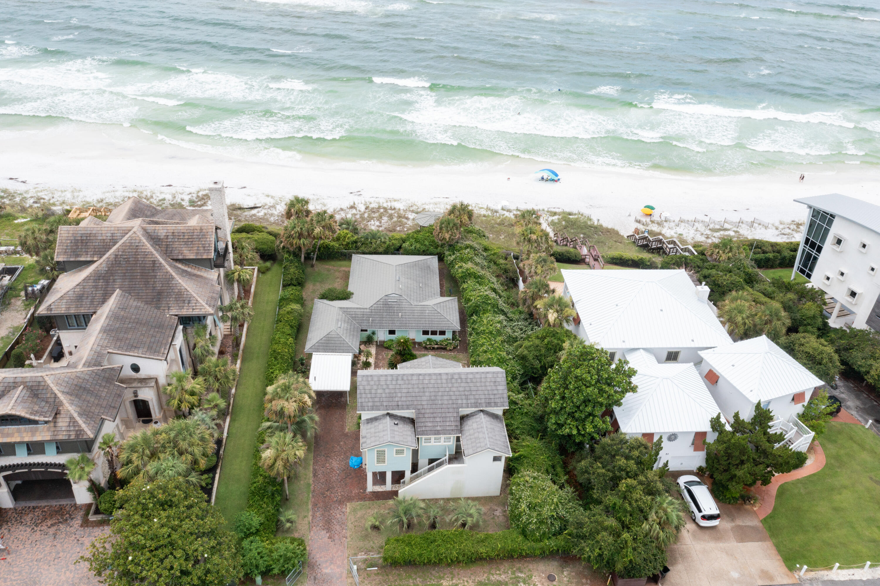 Perched high on the bluff in the desirable Seahighland neighborhood, this exceptional property boasts 87 feet of breathtaking Gulf front views.Explore various opportunities by updating the current home or utilizing the vacant lot to build your dream BEACHFRONT home in one of the most sought-after locations on 30A!Nestled on this lot is a charming 1948 two-bedroom, two-bath house, exuding 1,100 square feet of Old Florida character. The property also features a private gazebo, perfect for enjoying cool breezes and panoramic Gulf vistas from its elevated position.Facing the street, you'll find a modern 2003 carriage house, offering 1,000 square feet of comfortable living space. This includes one bedroom, one bath, a kitchen, a living room, and a dining room, all easily accessible via an elevator. The carriage house also comes with a spacious, air-conditioned garage, two storage spaces, and a laundry room. Enjoy stunning Gulf views from the two outdoor balconies, providing a serene retreat for relaxation. This property has been lovingly built and occupied by the current sellers. Additionally, the location offers convenient access to three public beach walkovers on Montgomery Street, making it a prime spot for beach enthusiasts. ***Buyer is responsible for personally verifying details about this property.  Any information contained in this listing is believed to be accurate but is not guaranteed.***