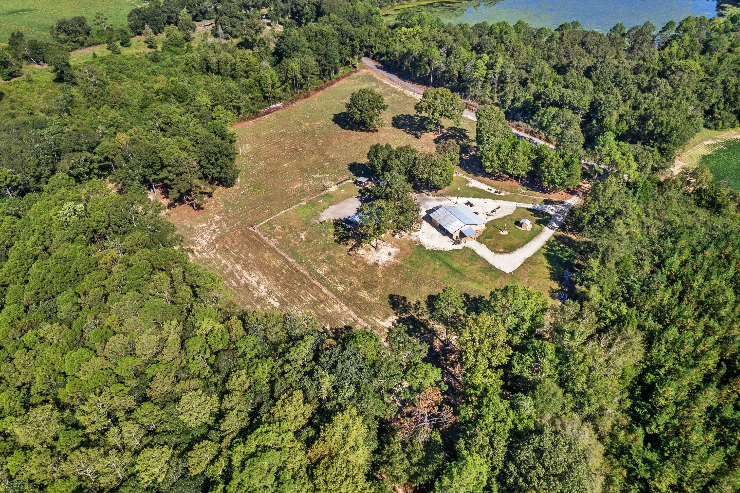Welcome to this charming coastal country retreat nestled on a sprawling 11.5-acre property. This unique 2-bedroom, 1-bathroom house with a loft combines the tranquility of rural living with the coastal design and feel, creating a truly captivating and harmonious living space only 1 hour away from the beautiful Destin beaches. The thoughtful design, natural surroundings, and versatile living spaces make this property a inviting haven for those seeking a laidback lifestyle.