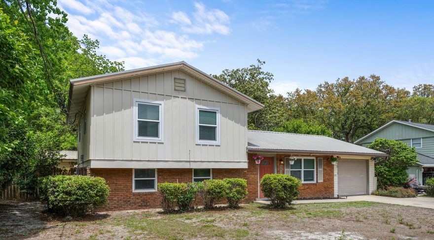 Welcome to 131 NW Sotir St, a tri-level home located in Fort Walton Beach, FL. Situated in the middle between Mary Esther and downtown FWB, your location couldn't be better. Shopping and dining options include Michaels, TJ Maxx, Chilis and Longhorns. For outdoor and recreation activities, you're only 2 mi from Liza Jackson Park, less than 1.5mi from FWB Rec Center and a short 4mi drive to the emerald waters and white sandy beaches of Okaloosa Island. This property features a new lawn pump replaced in April 2025, a water heater from 2020, and a metal roof installed in 2013. The kitchen offers ample cabinets, counter space, tile flooring, a large window for natural light, and a pantry cabinet. On the bottom level, you'll find a bonus living space, a full bathroom with a glass door tiled shower, a bedroom with a pocket door for privacy, and a large laundry room with storage space and your utility space for the w/h and furnace. The second floor boasts real hardwood floors, spacious bedrooms with ceiling fans, and a master bedroom with a screened deck entry point, access to a full bathroom, and floor-to-ceiling double closets. The property is equipped with an ADT-supported security system. Outside, enjoy a large backyard with an open patio space, storage space under the screened deck, and a yard building.