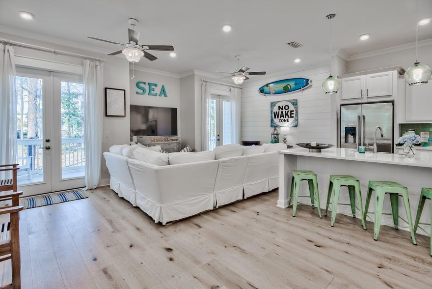Vintage elegance with a touch of coastal beach charm defines this stunning 3B/2.5B townhome in the popular community of Prominence on 30A. With more than $20K+ in well-appointed upgrades including shiplap accent walls, built-in bench seating in the dining room, custom designed triple bunks and shelving, this stunning coastal home fully maximizes living and entertaining space and rental potential. The open concept living room has ample seating and custom built-in banquette seating to host large family gatherings.  First floor includes 10 foot ceilings, chef's kitchen complete with quartz counters, stainless Electrolux appliances, farmhouse sink and turquoise tile backsplash. A whimsically painted staircase with coastal elegant d??cor and inviting artwork invokes all the charm of vacationing or enjoying a second home on 30A. Custom designed three-tiered bunks add to the charm of the 'whale-inspired' guest room located on the second floor. Second queen guest room with vintage accents is located steps from the second full bath. A stunning light-filled ensuite master bedroom is thoughtfully decorated with king wrought iron bed, double vanities, rain shower and large walk-in closet. This fully-furnished home is located in a prime section in Prominence North walking distance to the pool and offers a large private deck that overlooks lush pine lands loop and native vegetation. Coveted two-car garage (a rarity to find on 30A) w/additional storage for beach chairs/toys/owner items is located in garage and another inside full laundry room on first floor. This home is on a rental program and boasts impressive rental projections of $50K even with heavy owner usage. 