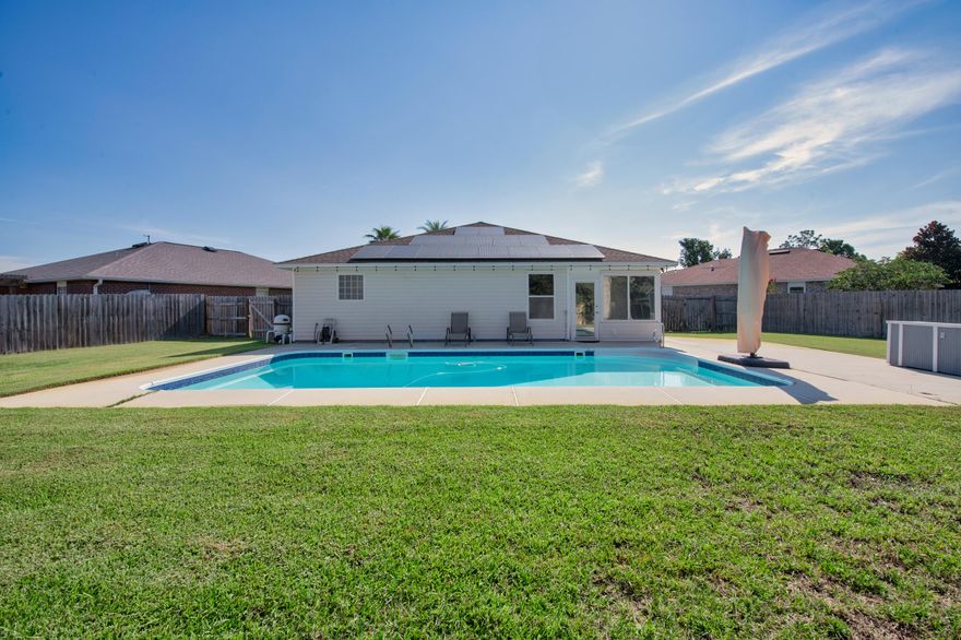 Welcome to your own slice of Florida POOL paradise in Gulf Breeze! Tucked away on a quiet cul-de-sac in Hidden Shores subdivision, this home combines comfortable living with exquisite backyard amenities rarely found in this price range. Step inside to soaring vaulted ceilings and a bright, open floor plan where the living room, dining area, and kitchen flow seamlessly together; perfect for lively gatherings, social cooking, and making memories with friends and family. French doors lead to a spacious master suite, offering room for a king bed, a luxurious garden tub, separate walk-in shower, and the largest master closet you'll find on the market today. Two additional bedrooms are generously sized, along with a cozy enclosed Florida room for year-round enjoyment. Out back, your private oasis awaits: a meticulously maintained swimming pool surrounded by lush green lawn, landscaped garden beds, and plenty of space for lounging or entertaining. A powered storage/work shed, metal planters, and mature landscaping make this yard as functional as it is beautiful.
And here's the best part, paid-off solar panels (with an acceptable offer) give you the freedom to run your home and pool on renewable energy, dramatically lowering utility costs for years to come.
From poolside weekends to neighborhood bike rides, this home is made for enjoying the Florida lifestyle to the fullest. All just a short drive from top-rated schools, beaches, shopping & dining and military installations. 

