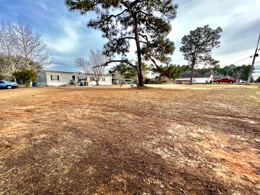 Cleared flat one acre lot. Roof 2020, HWH 2025. The section surrounding the home is fenced.  The remainder of the property is cleared. Workshop is separate and is a good size. Any subdivision of the lot would be the responsibility of the buyer.  Buyer's responsibility to confirm that the property  continues to be zoned to allow livestock.