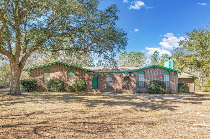 ROOM TO ROAM on this beautiful 6 acre lakefront property!  Older home that needs updates but still has good bones and plenty of living space.  Family room has stone front gas fireplace, built-in shelving and is located off the living/dining room.  Kitchen has loads of cabinets, breakfast nook area and cozy covered porch on the back.  All bedrooms are a good size - no carpet in these rooms.  Utility room houses the hot water heater but plenty of space for shelving or cabinets, the laundry room is located right next to it-both have access to rear patio.  Oversized covered carport and storage rooms as well.  Chain link fencing in backyard for pets and kids, yard maintenance beyond the fence will restore the beautiful view of the lake. Home being sold 'AS IS' only.