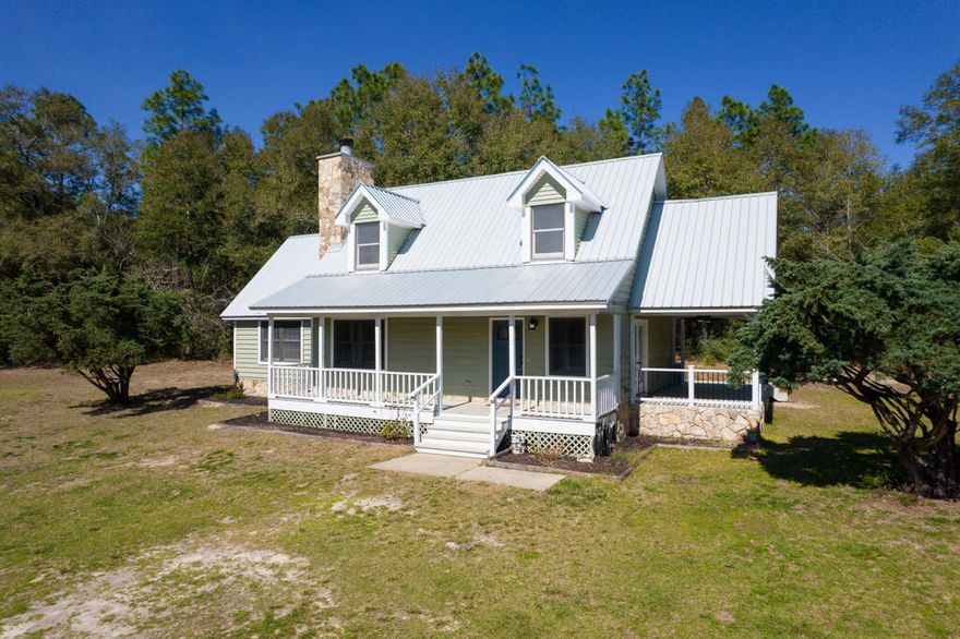 If you've ever dreamed of relaxing on a classic front porch, your perfect farmhouse is here! Nestled on well over 4 acres, this beautifully remodeled 3-bedroom, 2.5-bath home offers modern comforts while maintaining its rustic charm.Step inside to find a stunning upscale kitchen featuring white Carrara Cambria quartz countertops, stainless steel appliances, and refreshed shaker-style cabinetry with new hardware. The entire home boasts brand-new luxury vinyl plank flooring, perfect for easy maintenance and allergy-friendly living.The spacious primary suite is conveniently located on the first floor, while two additional bedrooms and a full bath are upstairs. Every bathroom has been updated with shaker-style vanities, quartz countertops, shiplap accents, new mirrors, and lighting.

Enjoy the outdoors from multiple covered decks or the heated and cooled Florida roomperfect for year-round relaxation. A gorgeous stone fireplace with a shiplap accent wall adds warmth and character to the living space.

Major upgrades in 2022 include a new metal roof, fresh interior and exterior paint, a new water heater, and a new HVAC system. The detached garage features updated metal siding, and the property includes a spacious pole barn, deep well and whole house water filtration system, and your own chicken coop.

If you're looking for privacy, acreage, and move-in-ready charm, this farmhouse is waiting for you!

