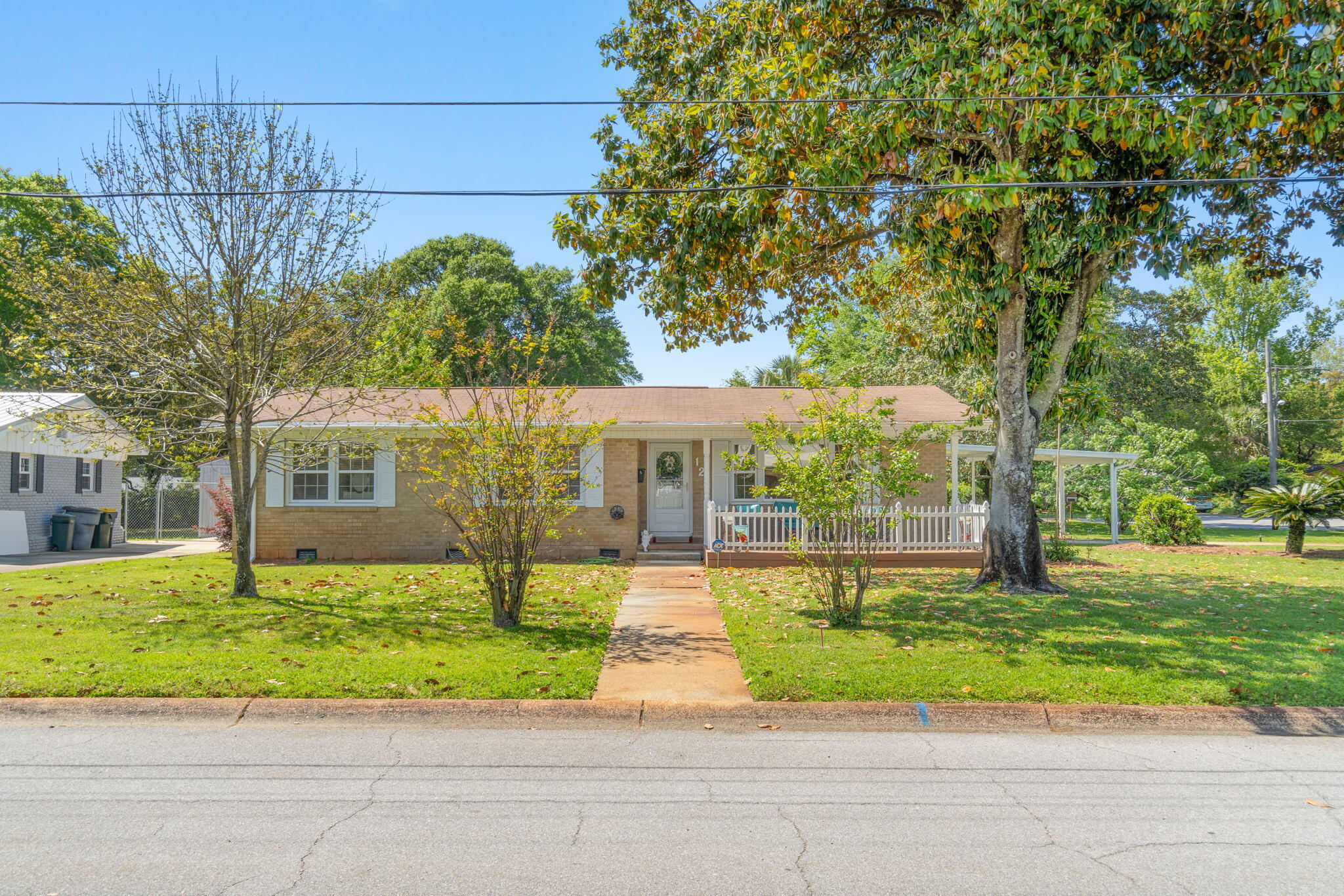 AGED TO PERFECTION and perfectly located in Elliott's Point neighborhood, just 0.8(e) mile to Uptown Station & 1.8(e) mile to the shopping district of downtown Fort Walton Beach. This move-in ready, low maintenance brick&vinyl, 3 bed/2 bath home has so many appealing features; a .24 acre corner lot, large front porch/deck shaded by a majestic Magnolia tree, 2 living spaces, kitchen/dining opens to both living areas, original wood floors in a good portion of the home, built-in bookshelves, indoor laundry, carport, fenced in backyard, lawn pump and sprinkler system, and a storage shed that conveys as is. The kitchen comes with stove, refrigerator, dishwasher, microwave, disposal, custom cabinets, and a window overlooking the family room. Next to the kitchen is the laundry area