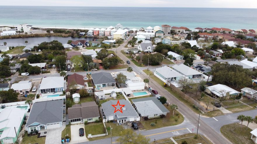Have you been looking for that perfect 'beach life style' home? Something not too big, tucked away from all the 'noise' from Panama City Beach? Then this home is for you! With vacation rental projects as high as $41k/yr, this cozy two-bedroom home is a short walk or quick golf cart ride to your community's private gulf coast beach access. Enjoy those warm sunrises and breathtaking sunsets day in and day out living your ideal beach life. This home features hurricane doors & windows, glass enclosed sun room, tile flooring throughout, marble tub/shower & bath vanity. The kitchen has custom cabinets with granite counter tops, kitchen pantry w/pull out shelves, lazy Susan in cabinets, and a built-in wine rack. Blinds, shades, curtains, and all appliances remain with the home. Relax under the covered patio off the master suite! The out building includes power & light w/additional outlets, and there's also a well w/ a sprinkler system. There's no HOA, so this could be a perfect investment opportunity those looking to own a vacation rental. Call to schedule a showing today!  