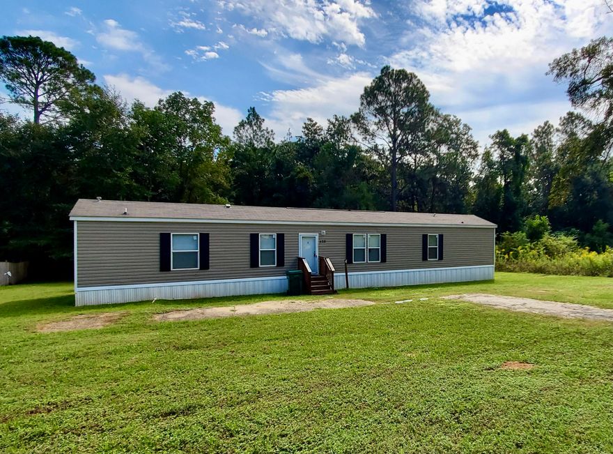 Quiet country living in the heart of Crestview! Situated on just over an acre is a 2017 Clayton Homes ''The Breeze'' floor plan with a huge front and fenced back yard with a storage shed - conveys 'as-is. The interior has vinyl plank flooring with carpeting in the bedrooms. The kitchen boasts stainless appliances, an island with bar seating and flows into the large living area. This is a great Investment to build a larger home! Plenty of room for your RV or camper, too! Call to schedule a showing today.