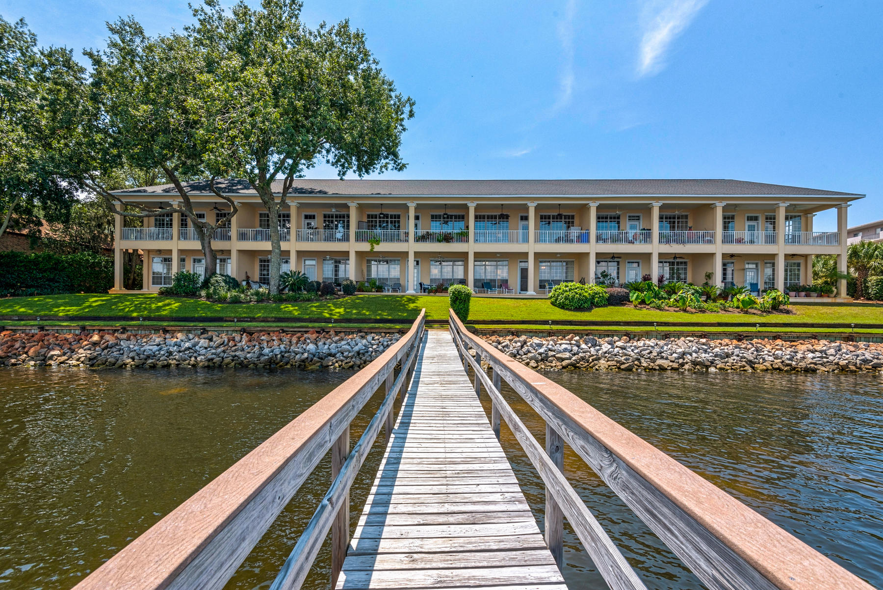 Million $$ View! Enjoy waterfront living at its best in this ground level condo with 10' ceilings that has astonishing views, spectacular sunrises and sunsets over the Chocatahachee Bay, dolphins at play, and fishing off the dock. This unit comes with a boat lift in a 20' slip. The interior of the unit has been freshly painted along with new carpet, wood-grain tile, granite in the kitchen and new appliances. Oak Harbour is located near the Destin Airport, Shopping, Restaurants, and all that the Destin lifestyle has to offer. Don't miss this opportunity to own a waterfront Bay unit. Perfect for those wanting to downsize or use as a 2nd home. There is one covered parking space in front of the unit. All dimensions are approximate and must be verified by buyer.