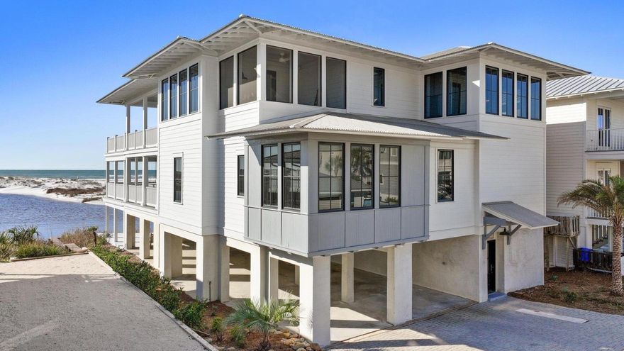 A symphony of elegance in Grayton Beach, Lollygag commands the most coveted location on 30A, where Western Lake meets the Gulf of America in an awe-inspiring convergence of coastal beauty. Positioned at the curve of the Grayton Beach outfall, this home offers a rare and uninterrupted panorama, with forever-protected views of the dune lake, sugar-white sands, and emerald Gulf waters. Its setting is as private as it is breathtaking.Designed with an emphasis on both luxury and resilience, Lollygag is a fortress of coastal design, featuring a bedrock-anchored seawall ensuring lasting protection without compromising the natural beauty that surrounds it. Inside, every element has been thoughtfully curated to create a home that is both extraordinary in design and effortless in function. A commercial-grade elevator provides seamless access across all three levels, while wide hallways enhance flow and accessibility.
The first floor is dedicated to comfort and convenience, featuring a steam room (sauna), full laundry, and half bath. The second level hosts two king suites, a queen suite, and a six-bed bunk room, each, except bunkroom, has its own private covered porch to take in the endless views. A handicap-accessible bath serves the bunk room, ensuring comfort for every guest. A swing bed on the second-floor porch provides a tranquil retreat, perfect for soaking in the coastal serenity.
The third floor is where Lollygag truly shines. A grand great room, private office, screened-in porch, and an expansive seaward-facing deck with another swing bed create the ultimate indoor-outdoor living experience. Whether gathering in the open concept living space or unwinding as the sun dips below the horizon, every moment in this home is framed by the natural beauty of 30A's most remarkable setting.
From its high-end appliances and integrated surround sound to its durable metal roof, hardboard siding, and Trex decking, every element of Lollygag speaks to quality and craftsmanship. Under-home covered parking with custom lighting enhances convenience, while two full outdoor showers offer the perfect way to refresh after a day on the water.
With an unrivaled location, timeless design, and a level of craftsmanship rarely found, Lollygag stands as a benchmark of luxury along 30A. Used as a second home and not a rental, its pristine condition and exclusivity remain intact. Private showings by appointment only. 
