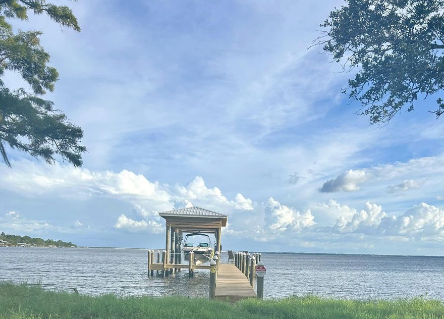 Beautiful Bay Front Lot with Southern Views toward the 331 Bridge. Cleared lot with TAP FEES ALREADY PAID & BRAND NEW BOAT DOCK with WATER AND POWER.  Boat lift installed with a 12,000lb capacity and can accommodate a boat up to 30ft in length.  Perfect for your bay or center console boat!  Boat, fish, Yolo or jet ski from your Bay front Paradise. Easy trip to North Beach Social or The Bay Restaurant!  Don't miss this incredible opportunity to build your dream bay front  paradise!