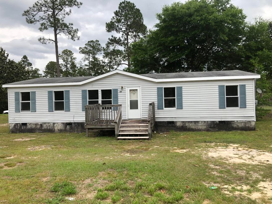 NEW ROOF just installed! This lot sits on one of Defuniak Spings lakes giving you beautiful water views. The spacious modular home holds 2 living spaces and a large master suite! New carpet installed last year and the floors in the kitchen and bathrooms are new this year with a new dishwasher coming!
