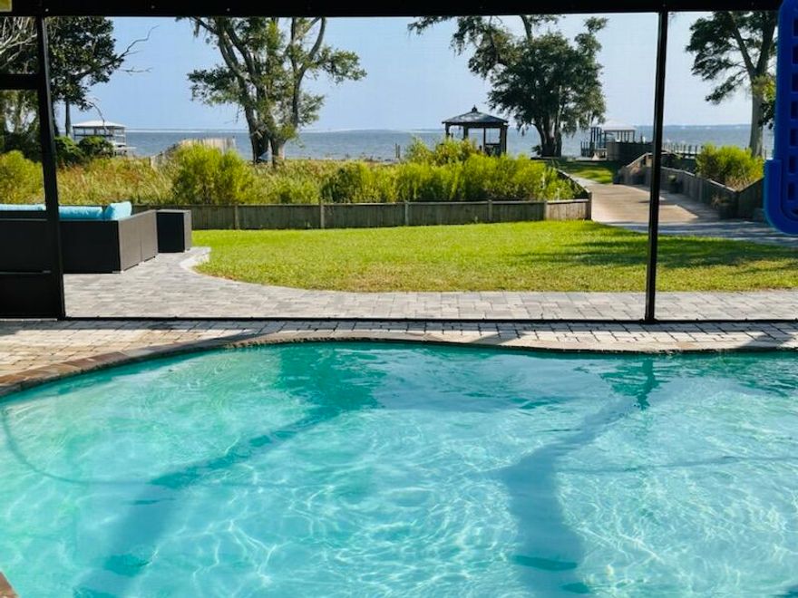 SELLERS ACCEPTING BACKUP OFFERS!  Waterfront Paradise offers captivating sunrises and sunsets on Choctawhatchee Bay along with all the dolphin watching, fishing, swimming, paddleboarding, & watersports fun your hearts can hold!!  

Unique Bayfront estate includes 3 Bedroom, 3 bath Main House (2,664 sq feet).  Also there is  a 1066 sq ft heated/cooled garage/workshop & 1 bedroom, 1 bath apt. (468 sqft).  The garage/workshop has overhead storage, 3 roll up doors, and plenty of space for your projects. The apt includes a separate entry, tile floors, full bedroom,a sitting room full bath & is plumbed for a kitchenette.  The outdoor living space is well integrated into the main living areas of the home, making this place perfect for entertaining.

So much more to tell you, I don't know where to start!!  As you can see, this unique estate offers a tremendous spread of space throughout the home and property with plenty of indoor/outdoor spaces for living, entertaining, relaxation and pure fun for all your family and friends.  

As you enter the main house, you will be greeted with captivating bay views from the fabulous open concept family, living, dining and kitchen areas.  Other mentions are the 9-10' ceilings, propane fireplace, large windows and hurricane rated sliders, and tile flooring throughout. The beautiful bay views overlook the large, enclosed pool added with a sand filtration system in 2019 and Jacuzzi Hot Michael Phelps Hot Tub.

The main kitchen offers stainless steel appliances (D/W replace 2023, Oven and Cooktop 2021) , solid counters, pantry and breakfast bar. The large Primary Bedroom with ensuite is a get-away to relax and pamper yourself includes - separate vanities, whirlpool tub, and cultured marble. You'll also enjoy his/her walk-in closets w/organizers. Off the dining/kitchen you will find a large laundry complete with abundance of laundry storage room w/sink & ironing board. This split floorplan has the (2) additional sizeable bedrooms on the opposite side of the home with shared bathroom.  
Lastly, the main house features an addition completed in 2019, which includes a kitchen/wetbar, a full bath, Insulated black out shades, and large walk-in closet/storage room. The owners use this as a waterfront family entertainment room off the pool area. However, it could be an amazing 5th bedroom/master suite or guest quarters.

Stepping outside you can enjoy your morning coffee and water views from the screened patio and pool area. This 350ft deep lot includes a large yard with many gardening opportunities and lovely natural wetland areas with an extra wide bridge crossing over wetlands. (Permitted for 20K lb weight.)  The waterfront includes a gazebo, a firepit, and incredible sunsets. 

It's only 4 miles to the Freeport Sports Complex 50 acre park and 18 miles to Santa Rosa Beach or Grayton Beach. No HOA & low utility bills.  As you can see this property is truly a "GEM" and is move in ready! This area is one of the Best Kept Secrets on the bay with so many activities available on 30A and 98 that you will never run out of things to do!  

Note: The lot size is incorrect in some county records. A survey is included to show the correct lot size of .75 acres. 

Updates/Upgrades/Timelines:
"Residential Detached Garage Completed 4/17/18
"Residential Swimong Pool Completed 8/09/19
"Residential Addition Completed 10/10/19  (Enclosed Carport)
Roof: 2001

Appliances:
"Samsung dishwasher -3 mos - Control by phone App.
"New stove top main house
"2 new sets of washer and dryer 
"Entertainment room/in-law suite has new fridge and dishwasher 
"And two freezers one in hall way in house and  one in the garage 

Other improvements/Notes:
"Pool pump replaced 5 months ago.
"Separate Meters for Main House and Apt/Garage
"Main House HVAC with Heat exchange. Full replacement of HVAC Units inside and out & insulation 2023.

"Main house is wired for full house generator (no generator) with large propane tank in place. The propane services fireplace, gas grill and full house generator.

"Apt/Garage is wired for Generac Generator.
"Apt/Garage has split unit.
"Added - 2 propane tanks
"Windows on Waterside only of the house have all been replaced with Storm Rated windowsl

"Replaced all the sprinkler system with new.
"All new fencing.
"Property is wired for landscape lights. 
"SheShed has window HVAC/Fan (Recently relocated to its new spot and items were disconnected.  Need to be reinstalled and connected back.)

"New $15,000 Seawall with rift raft. 
"100Amp Service at the Gazebo with water/electric 
"All new dock and boathouse with new swing jet ski lift.  The Boat lift was not reinstalled after the storm.

"Owners have upgraded the following:
"Gutters and downspouts house and garage 
"Bridge with lights
"New outdoor lights all over property 
"New Pavers from bay to street $120,000
"High rise toilet
"New pool pump