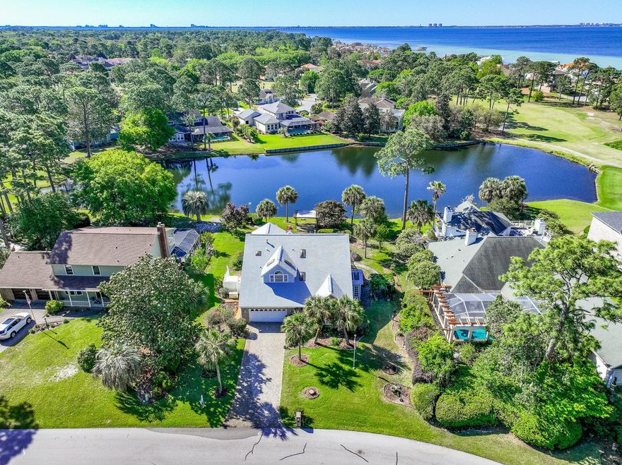 LAKEFRONT LIVING IN GATED SOUTHWIND - ROOM TO UPDATE, VIEWS TO INSPIRE. One-owner lakefront home in the gated community of Southwind, Bluewater Bay. This 3 BED, 3 BATH home offers 2,924 SF of space, with all bedrooms upstairs--including a SERENE PRIMARY SUITE W/ COVERED BALCONY OVERLOOKING THE LAKE. Enjoy formal living and dining rooms, an open kitchen/den with gas fireplace, and a SCREENED-IN GUNITE POOL perfect for relaxing. Gas stove, heat and water heater, FULL HOUSE GENERATOR AND CENTRAL VAC, and some newer windows already in place. PEACEFUL SETTING, tons of potential--bring your vision!