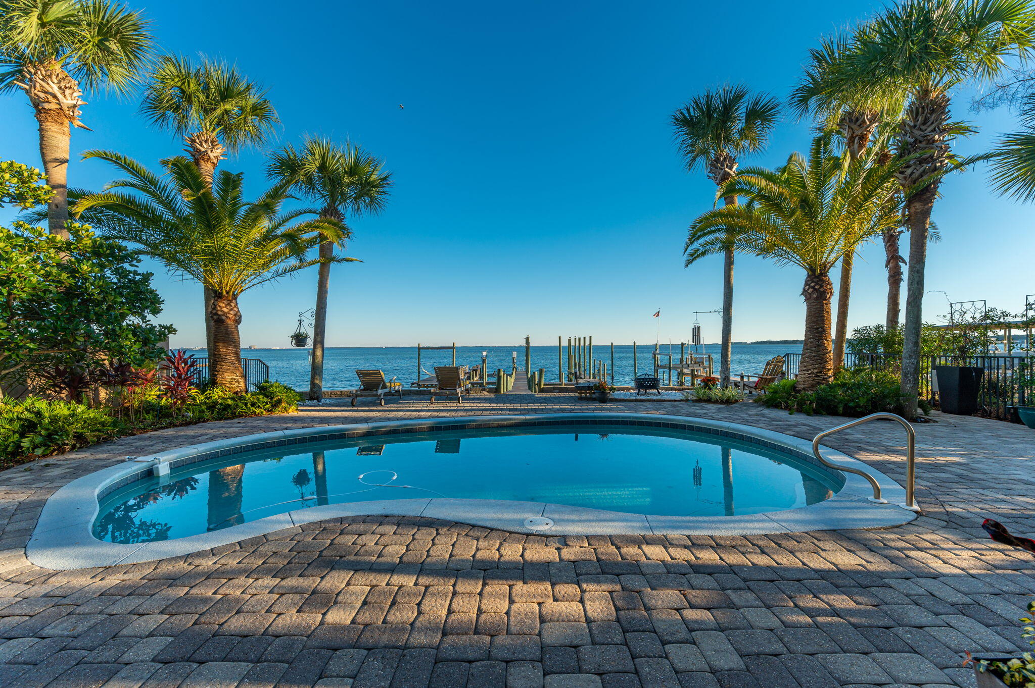 NOW PRICED BELOW APPRAISAL!!! The unofficial theme song for this bayfront masterpiece is Otis Redding's 'Sittin' on the Dock of the Bay.' That's because it's hard to tear yourself away from the dock that is nothing short of magnificent. Superbly maintained, the dock takes you over pristine Choctawhatchee Bay waters to a 17' wide boat slip (can safely dock up to a 70-footer); a raised boat lift for a smaller skiff; a launch platform for jet skis, kayak or paddle board; a 15' by 55' entertaining dock, with sitting area and dining area; and, when you are ready for some 'me time,' a relaxing spot to hum 'Watchin' the tide roll away' as the breeze gently sways your hammock. Turn away from the dock and the music plays on. The large pool deck and pool; covered porch; PLEASE READ MORE