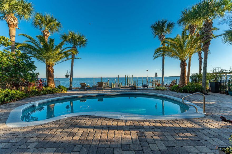 NOW PRICED BELOW APPRAISAL!!! The unofficial theme song for this bayfront masterpiece is Otis Redding's 'Sittin' on the Dock of the Bay.' That's because it's hard to tear yourself away from the dock that is nothing short of magnificent. Superbly maintained, the dock takes you over pristine Choctawhatchee Bay waters to a 17' wide boat slip (can safely dock up to a 70-footer); a raised boat lift for a smaller skiff; a launch platform for jet skis, kayak or paddle board; a 15' by 55' entertaining dock, with sitting area and dining area; and, when you are ready for some 'me time,' a relaxing spot to hum 'Watchin' the tide roll away' as the breeze gently sways your hammock. Turn away from the dock and the music plays on. The large pool deck and pool; covered porch; PLEASE READ MORE