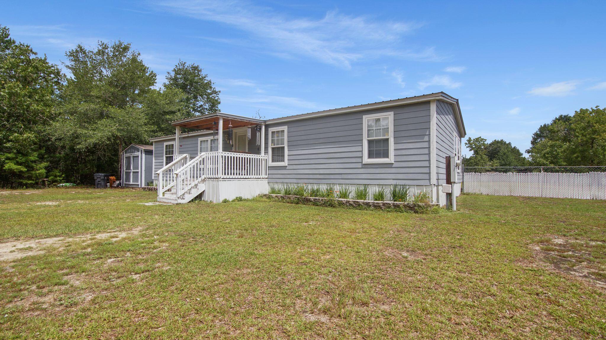 Welcome Home to this impeccably maintained property on over 1 acre located just 10 minutes from downtown DeFuniak Springs. The home has hardy plank siding and a large, covered porch for entertaining.The primary bedroom and bathroom have been redesigned to create a relaxing retreat while the rest of the home is spacious and thoughtfully laid out. The floor plan is split with the other two bedrooms being off of the living room,. while the primary bedroom if off of the foyer. The backyard is fully fenced for your pets' safety. There is a storage building complete with electricity for additional storage needs.