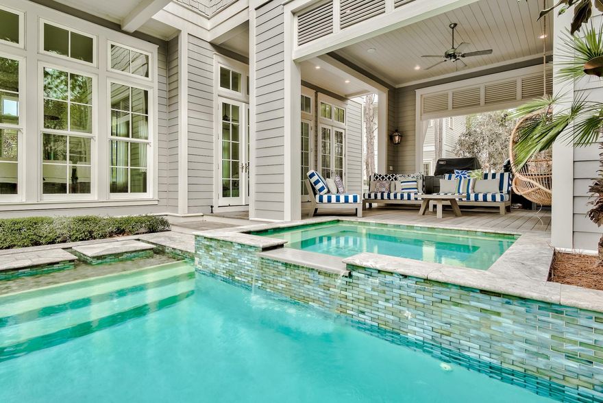 Corner Lot overlooking pond in WaterColor  meticulous 4 BR/4.5 BA home with private swimming pool and outdoor living room is defined by its flow and natural light. Built by Jason Romair with abundant windows allowing views of pool and outdoor space with light hardwood floors and soaring ceilings. A marble island that comfortably seats six is the centerpiece of the fully-equipped kitchen with custom cabinetry, dual sinks and commercial grade appliances. The living room provides ample space for family to gather and leads to a covered cabana room complete with outdoor fireplace and access to the spa and pool. The second story offers two guest rooms with ensuite bathrooms, a sitting area with balcony and an exquisite master suite with a stunning marble bathrooms each with their own closets. The pond views create a peaceful setting and sense of privacy with occasional Heron viewings.