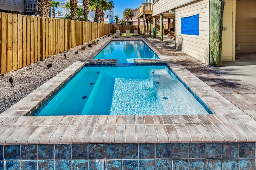 Beautiful, modern custom built 3 bedroom/2 bathroom home. What makes this home special? The ONLY home you will find on the market combining (1) close to public beach access .. only 800 feet from the Ariola Drive Public Beach Access with a sidewalk on the side of the home to take you to the public beach access, (2) ALL square footage elevated on pilings, and (3) amazing pool with HOT-TUB. The homeowners spent almost $150,000 on the exterior installing an inground pool with attached hot tub and waterfall, and turf area for family games. Fully fenced backyard with plenty of room around the pool to layout, cookout, play games and entertain. Inside, you will find a 3-bedroom split plan with tall ceilings and lots of light.  The living room and spacious master bedroom attach to a covered outdoor deck. Sonos system on backyard deck, around pool, and living room area to enjoy music throughout the home.
The master bedroom has luxurious master bath with large separate walk-in shower with soaking bathtub.  The additional two bedrooms are separate and provide sleeping for up to 8 people. A sofa sleeper in the living room also provides additional accommodation. You can't beat the location being about 1 mile from boardwalk with numerous bars, shops and restaurants. It is two blocks from Via De Luna where you can watch the Mardi Gras Parade, Christmas parade or walk/jog/cycle the miles of sidewalks. Play pickleball?  Outdoor courts are one mile away and indoor courts are just a little over 4 miles way.  With over $82,000 in rental income from April through December of 2024, this house with NO HOA will pay for itself!