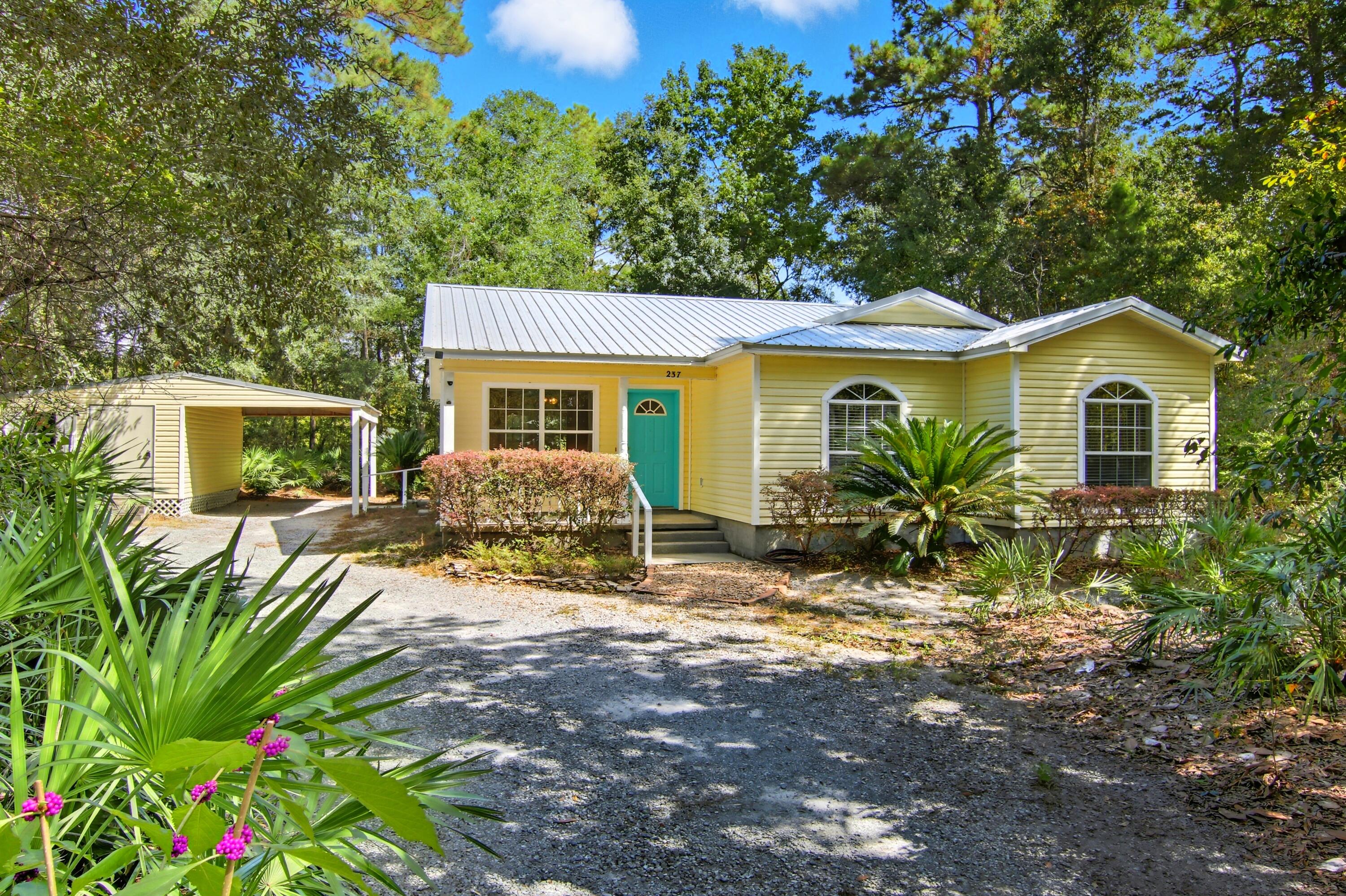 Once upon a time, there was a little Florida cottage tucked among the palms in Freeport. It wasn't flashy or loud--it was the kind of home that instantly made you feel welcome, the kind of place where time slows down and the world feels just a little softer.This 3-bedroom, 2-bath retreat features an open-concept living area, a new metal roof, and all appliances conveying for your convenience. On over half an acre of lush, tropical greenery, mornings are best spent with coffee on the screened-in porch, while evenings invite quiet conversations beneath the stars.But this cottage offers more than charm--it offers freedom. With no HOA, you're free to create the lifestyle you've been dreaming of. A 20x10 storage building with connected carport provides plenty of space for hobbies, tools, or beach gear, and parking for 3-4 vehicles means friends and family are always welcome.
Perfectly placed in Lagrange Shores, the heart of Freeport just outside Hammock Bay, this home sits in Flood Zone X (no flood insurance required) and is only minutes from Choctawhatchee Bay and the sugar-white beaches of the Emerald Coast.
This isn't just a house. It's a place to rest, recharge, and call home. Give us a call today for your private tour!