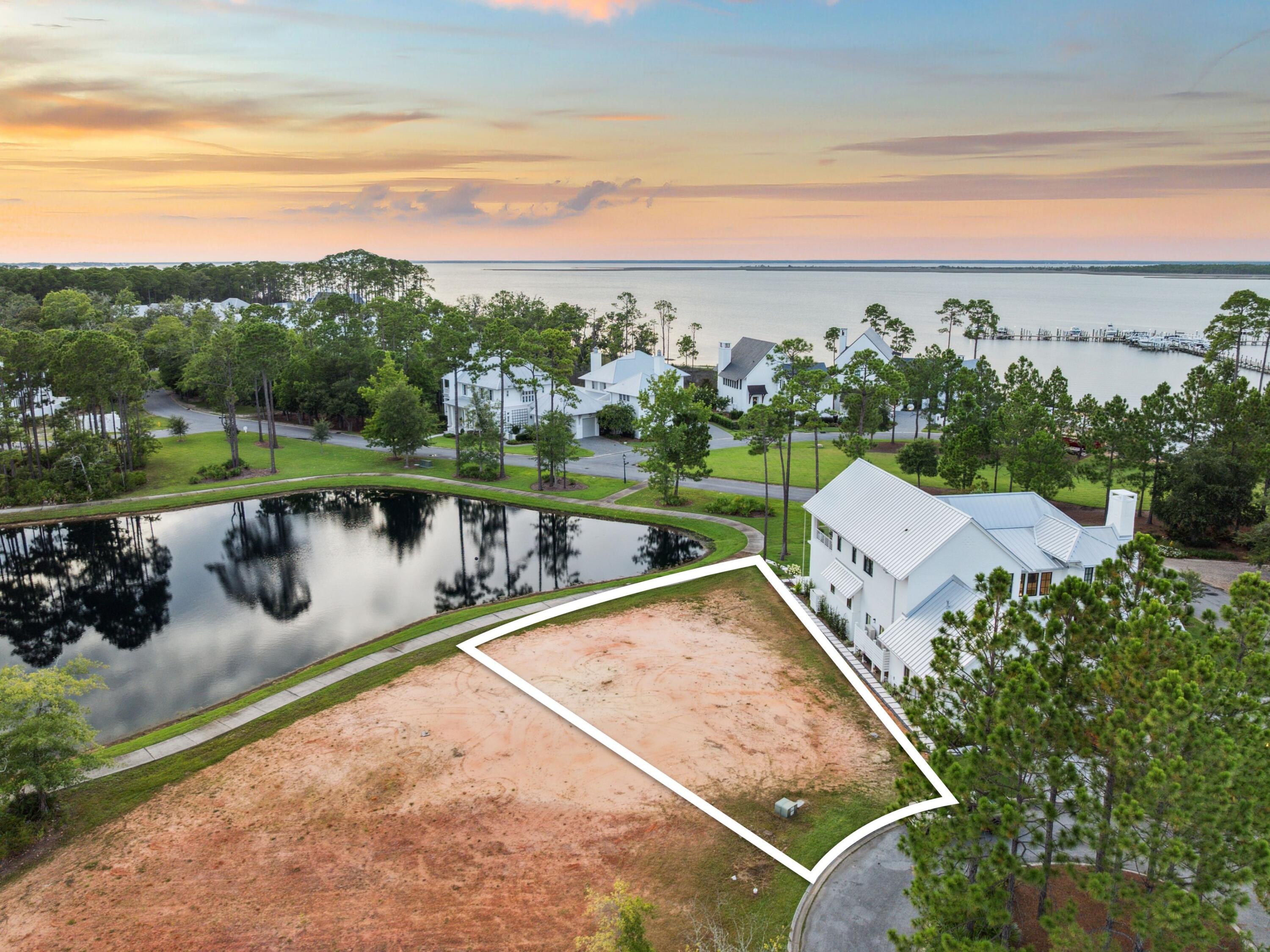 Situated near the heart of the Churchill Oaks community, Lot 82 offers a rare opportunity to build your custom home just steps from the neighborhood's premier amenities. This spacious homesite backs up to the scenic boardwalk that wraps around the neighborhood, offering peaceful views and easy access to nature right from your backyard.Located just a short stroll from the clubhouse, Lot 82 is ideally positioned for enjoying everything Churchill Oaks has to offer. The clubhouse features a resort-style pool, a state-of-the-art fitness center, and walking trails that meander through lush, landscaped grounds. Residents also enjoy access to a deep-water marina with private boat slips, paddleboard storage, and a fish cleaning station. With its boardwalk setting and close proximity to the community hub, Lot 82 is a prime opportunity to create your ideal coastal retreat in one of Santa Rosa Beach's most prestigious neighborhoods.