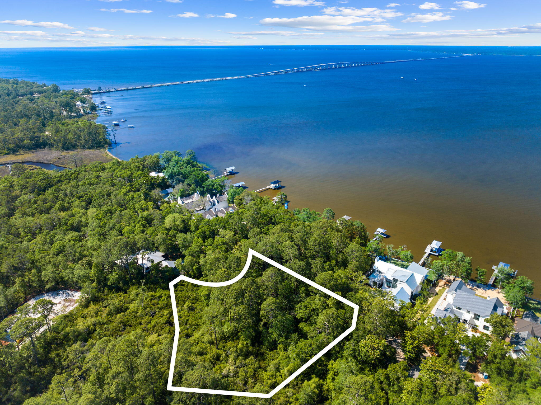 Exclusive Half-Acre Lot in Estuary - 30A's Hidden Gem! Welcome to a rare and remarkable opportunity to own a piece of paradise in Estuary--an intimate nature-rich enclave along the sought-after 30A corridor. This half-acre old-growth wooded lot offers the perfect blend of luxury, privacy, and natural beauty, nestled in a quiet cul-de-sac and bordered on three sides by protected conservation land. Set within Estuary, a private gated neighborhood of less than 40 lots and celebrated for its unspoiled landscapes and upscale ambiance, this homesite offers both seclusion and proximity to 30A's world-class beaches, dining, and recreation. Detailed Survey available. With access to the neighborhood boardwalk, dock and bay, and potential for stunning water views from your future home, this lot invites you to connect with the peaceful rhythms of the coast. Surrounded by conservation land and tucked at the end of a quiet street, this lot offers exceptional privacy- a sanctuary to retreat, relax, and recharge. This is more than just a lot - it's a foundation for a lifestyle, a vision, and a future filled with memories.
Estuary residents enjoy gated entry, bay access, boardwalks, scenic surroundings, and the privacy of a community made up of less than 40 lots. Whether you're looking to build your forever home or a refined coastal retreat, this extraordinary lot in The Estuary offers unmatched value and vision.