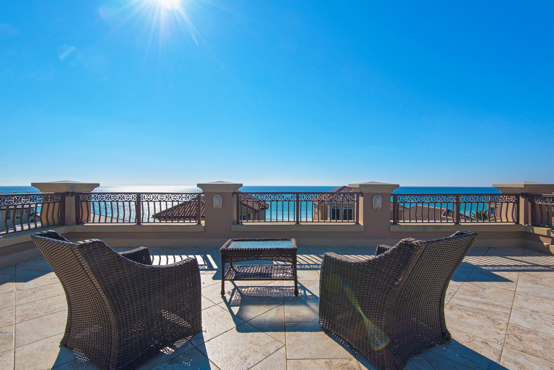 European splendor at the beach. This exquisitely designed home boasts Destin's most beautiful roof top deck with 360 degree views of the Gulf and surrounding skyline.Step inside the front foyer and you instantly realize that this is a home like no other. It clearly is custom built with European influences that include coffered ceilings, travertine floors, unique chandeliers and imported features. The rooftop deck has a new TV, brand new gas grill. fridge, ice maker and sink. The Gulf views are nothing short of breathtaking. From this 4th floor roof, you enter the house and pass the half bath on your way to the elevator or you can take the stone steps down to the 3rd floor where there is a guest bedroom with an ensuite bath and oversized closet. There is a laundry room and of course